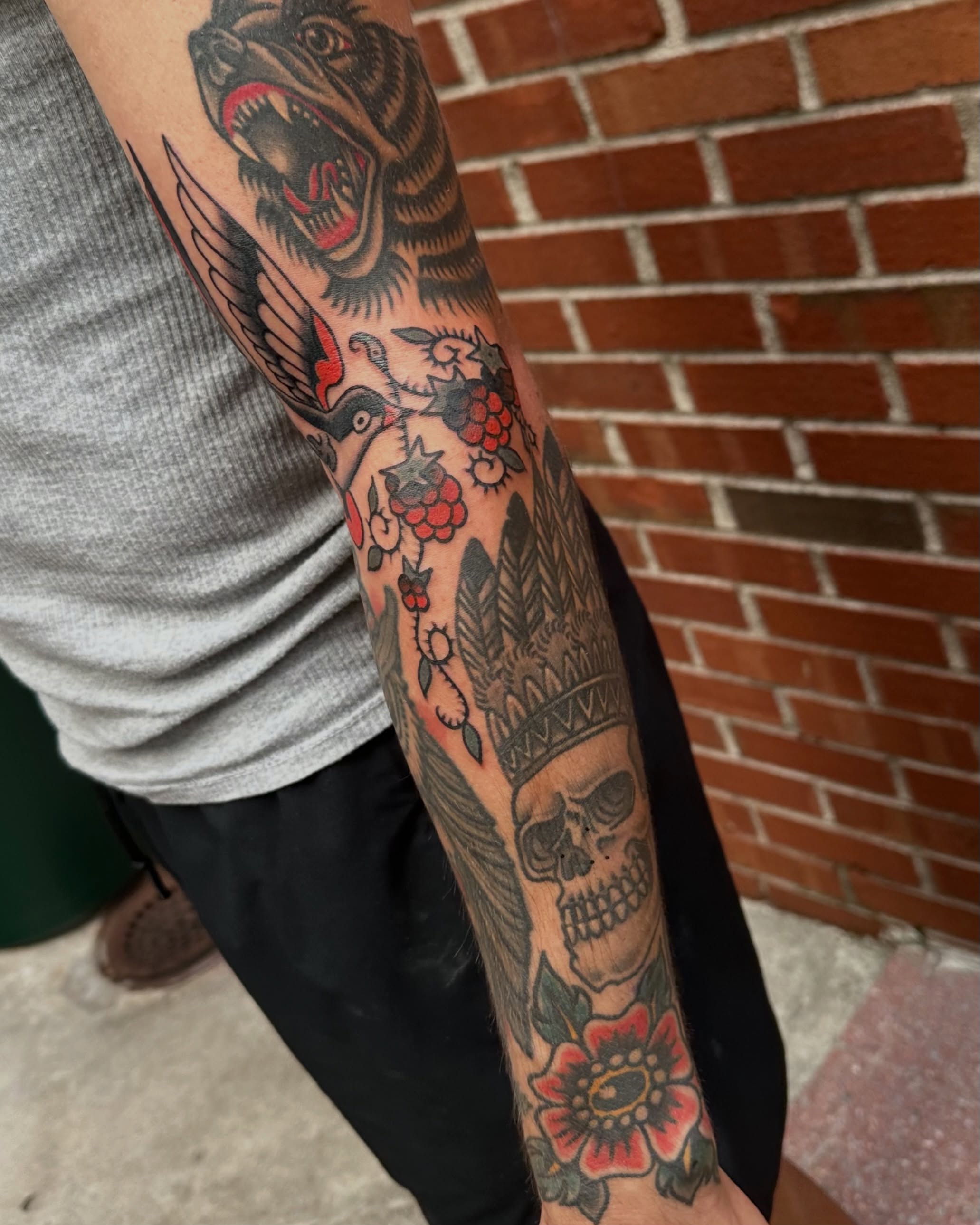 Wolf and flowers American traditional tattoo on the forearm by rachel knabe