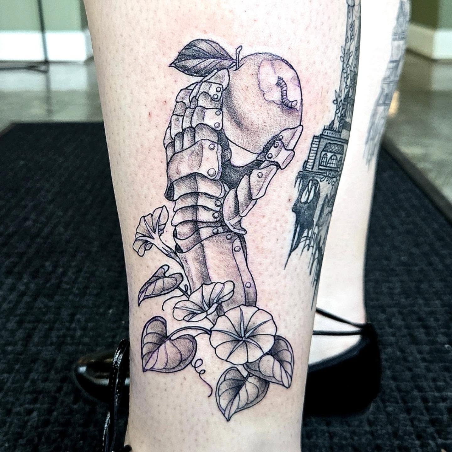 Apple and skeleton hand realism tattoo on the forearm by Amanda Hinrichs