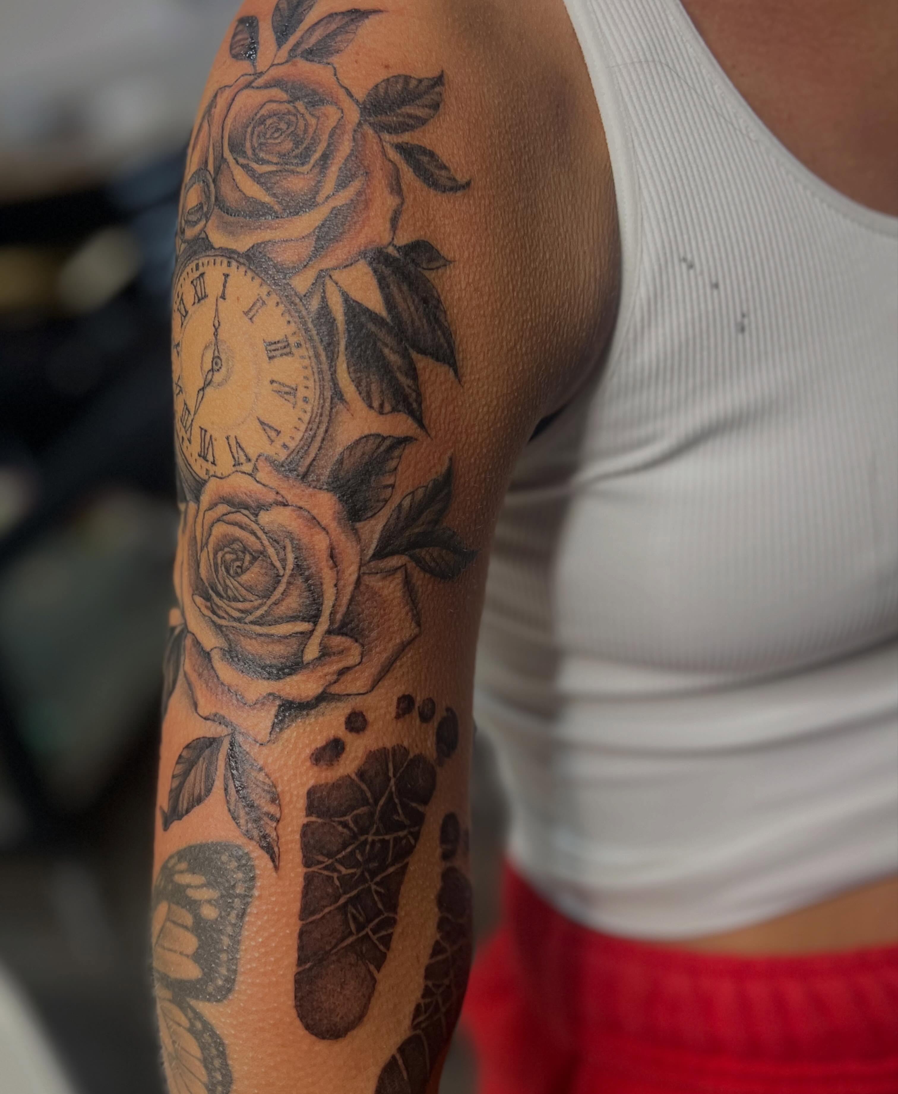 Roses and clock realism tattoo on the forearm by Rikki
