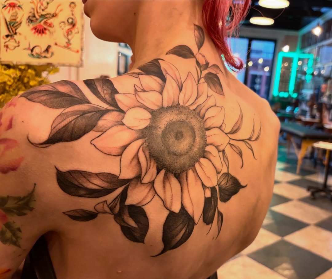 Sunflower realism tattoo on the back by Leah Leinani