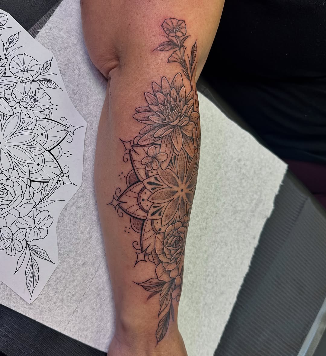Floral arrangement geometric tattoo on the forearm by Kat Bennett
