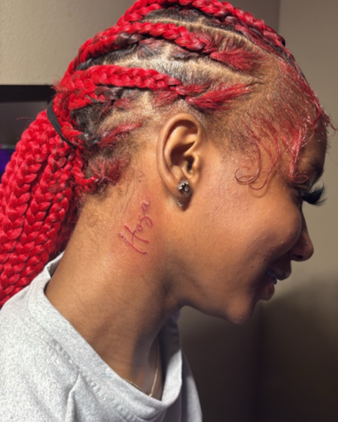 Name lettering script tattoo on the neck by K.L Tattoo Uptown