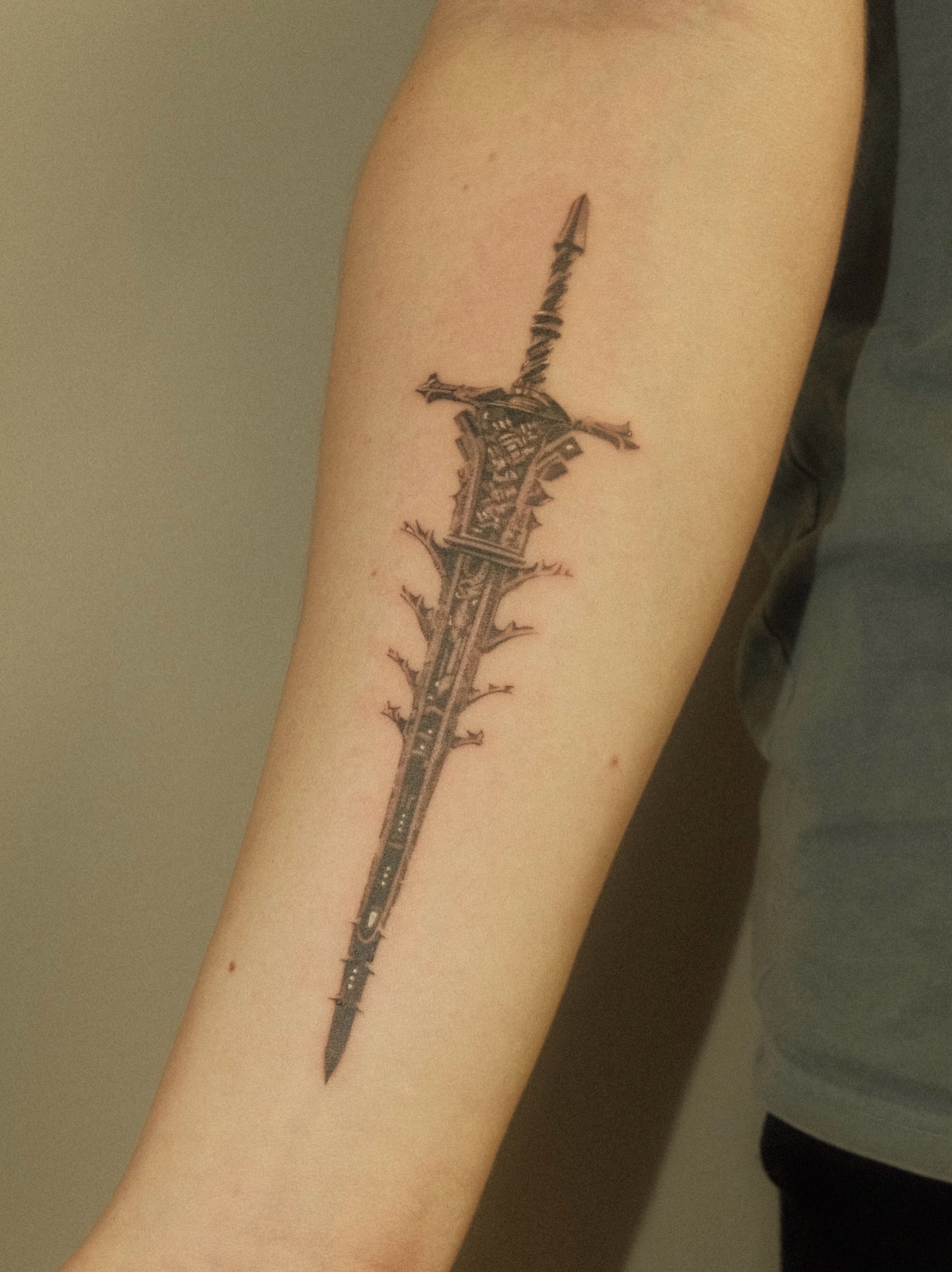 Sword black and grey tattoo on the forearm by Thiên Hồ