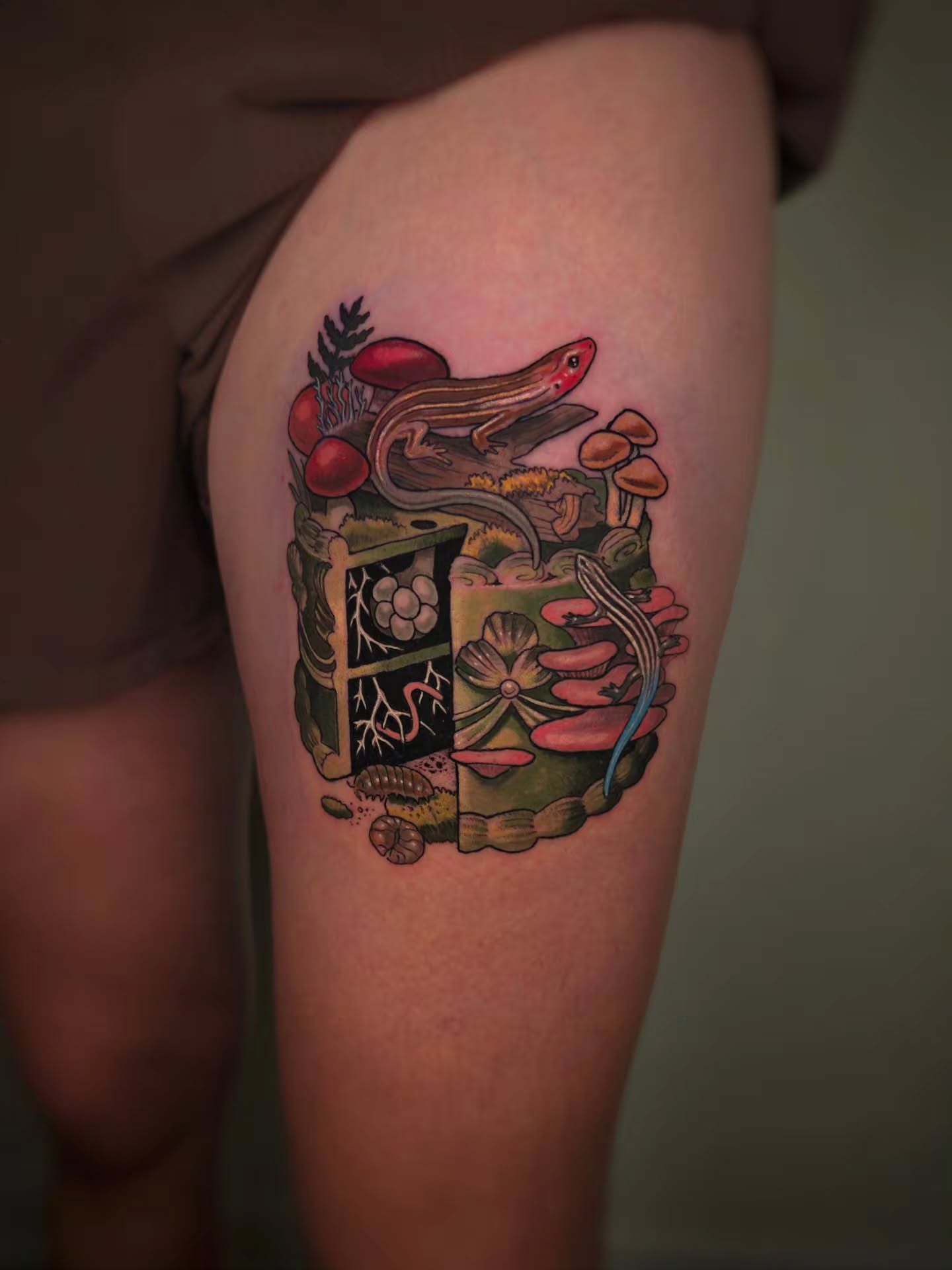 Lizard and mushrooms new school tattoo on the thigh by Whitney Caskey