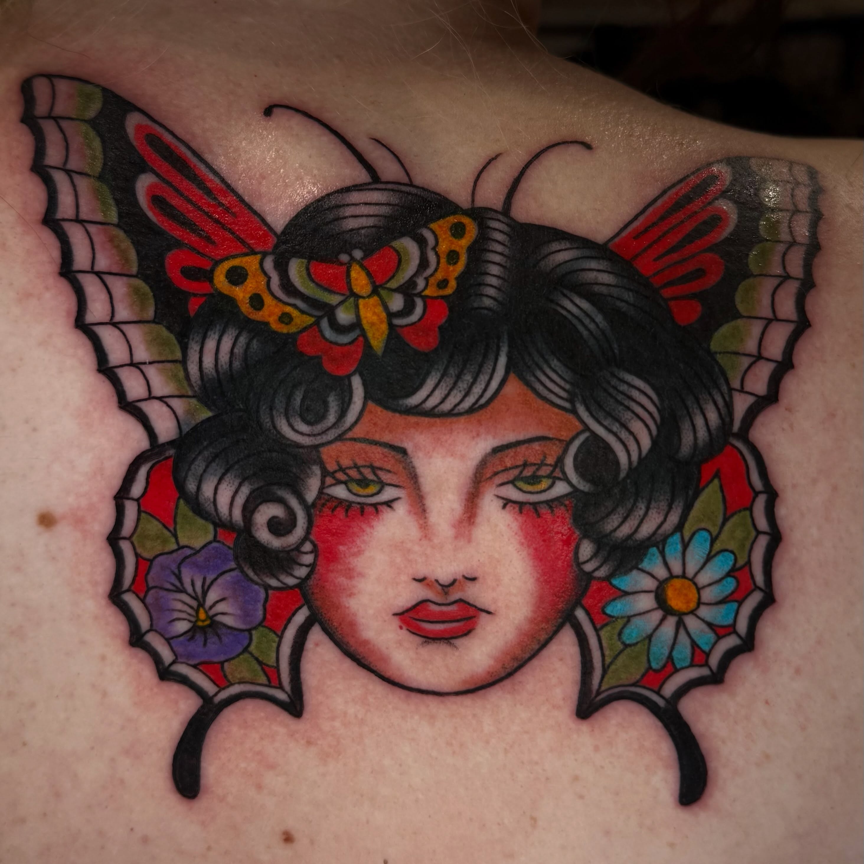 Woman with butterfly American traditional tattoo on the back by Kiera ❤️‍🔥