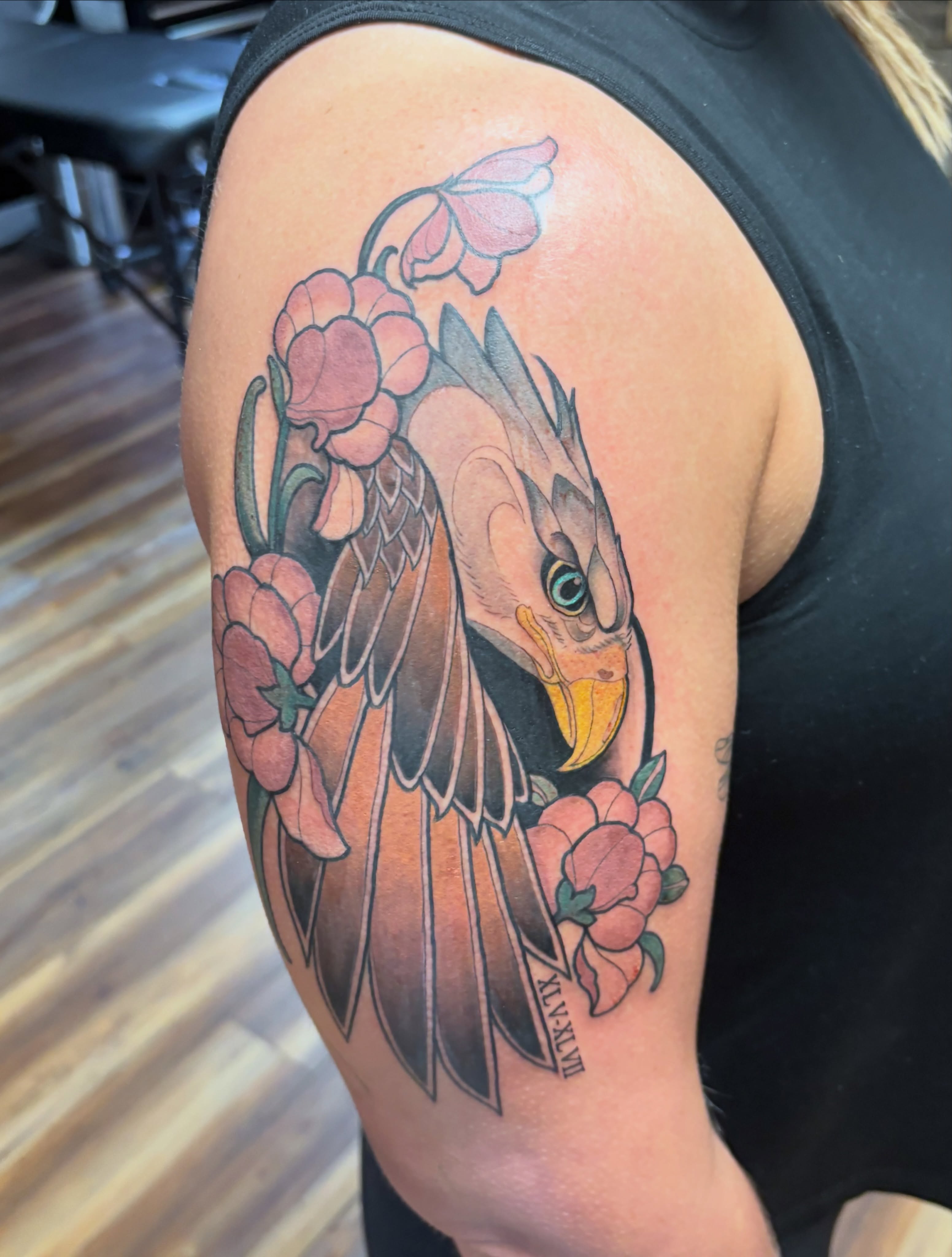 Bird and flowers realism tattoo on the shoulder by MJ Saunders