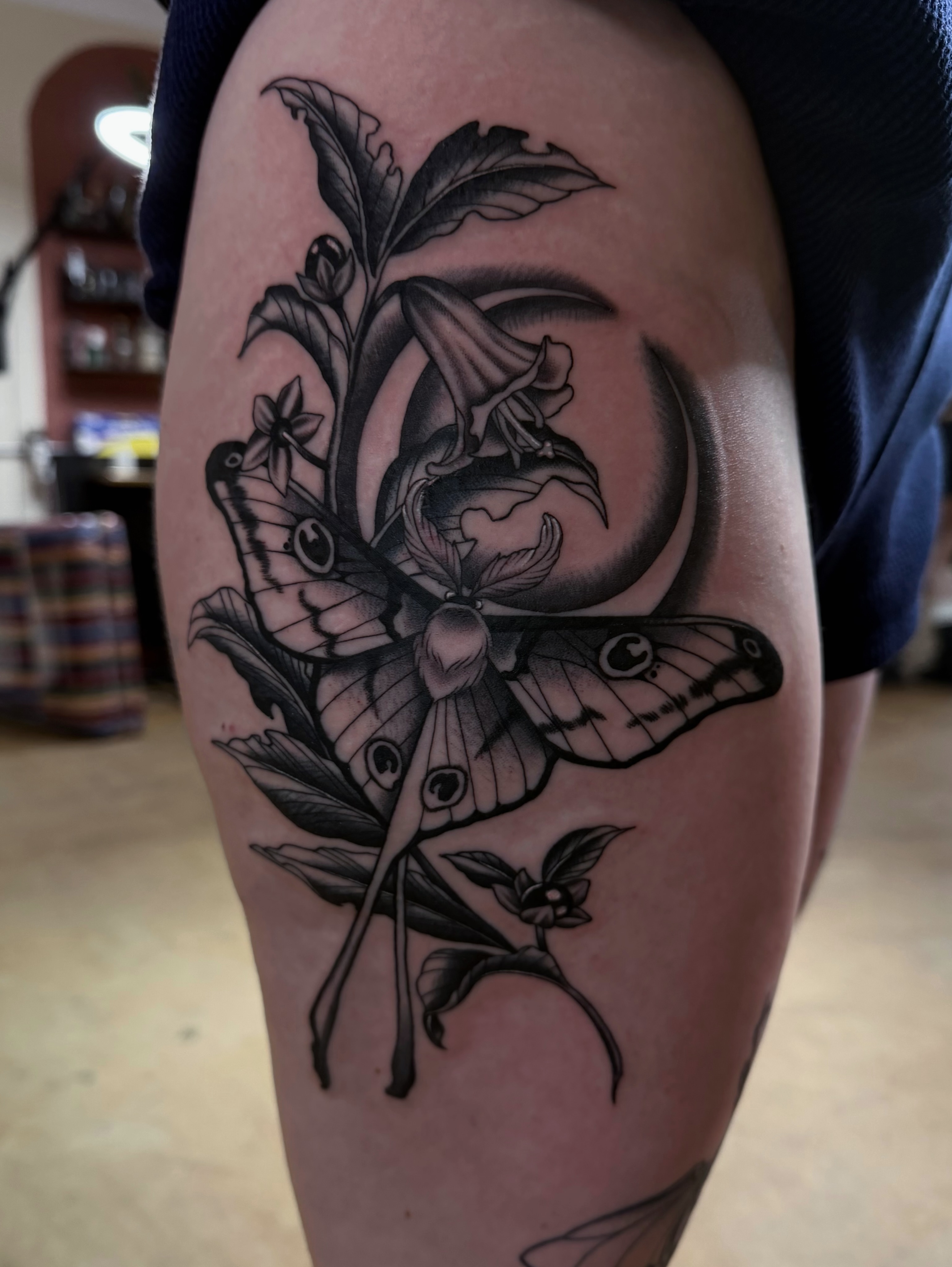 Butterfly and moon realism tattoo on the thigh by Sacramento Tattoos (Ilona)