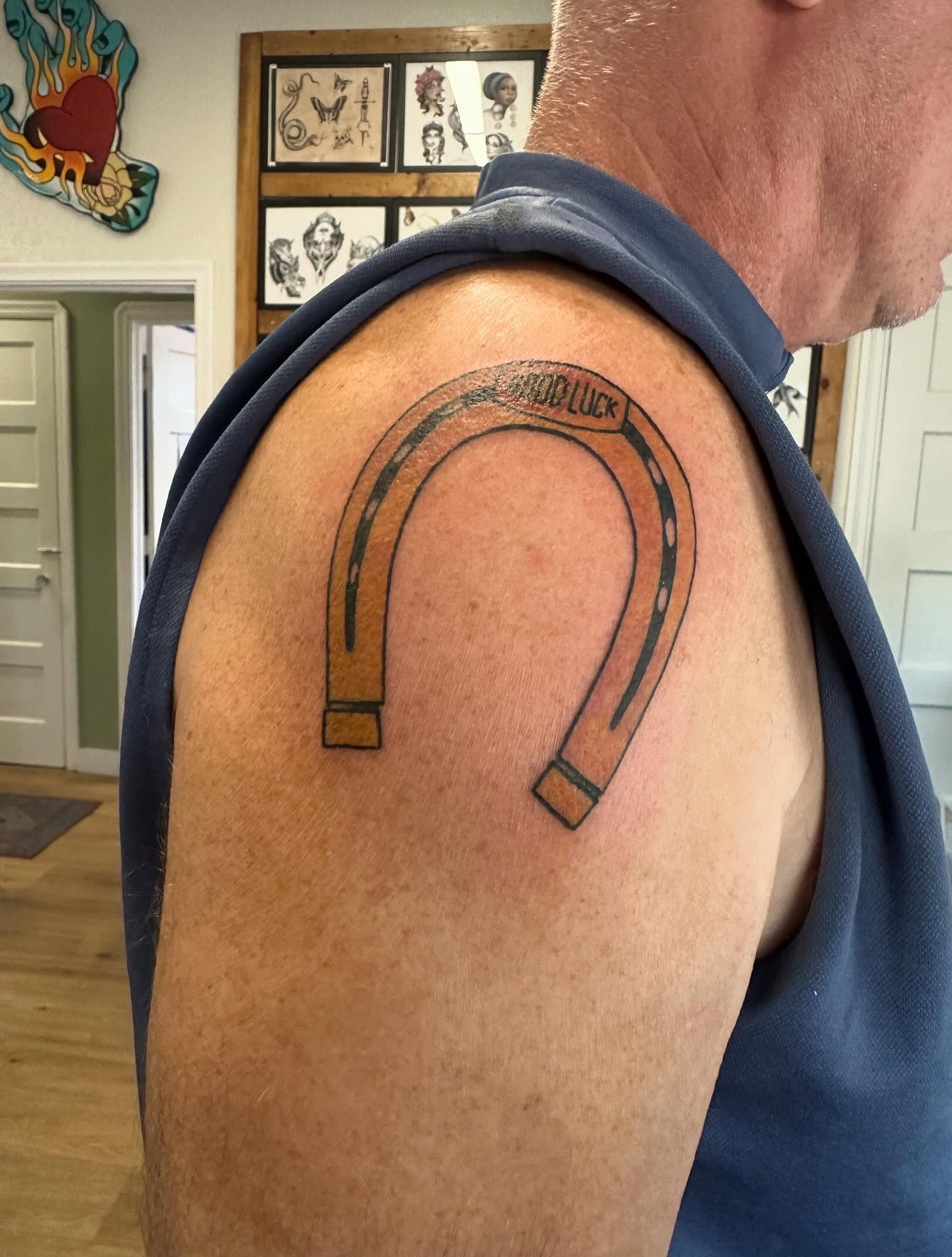 Horseshoe American traditional tattoo on the shoulder by Kaylee Woods