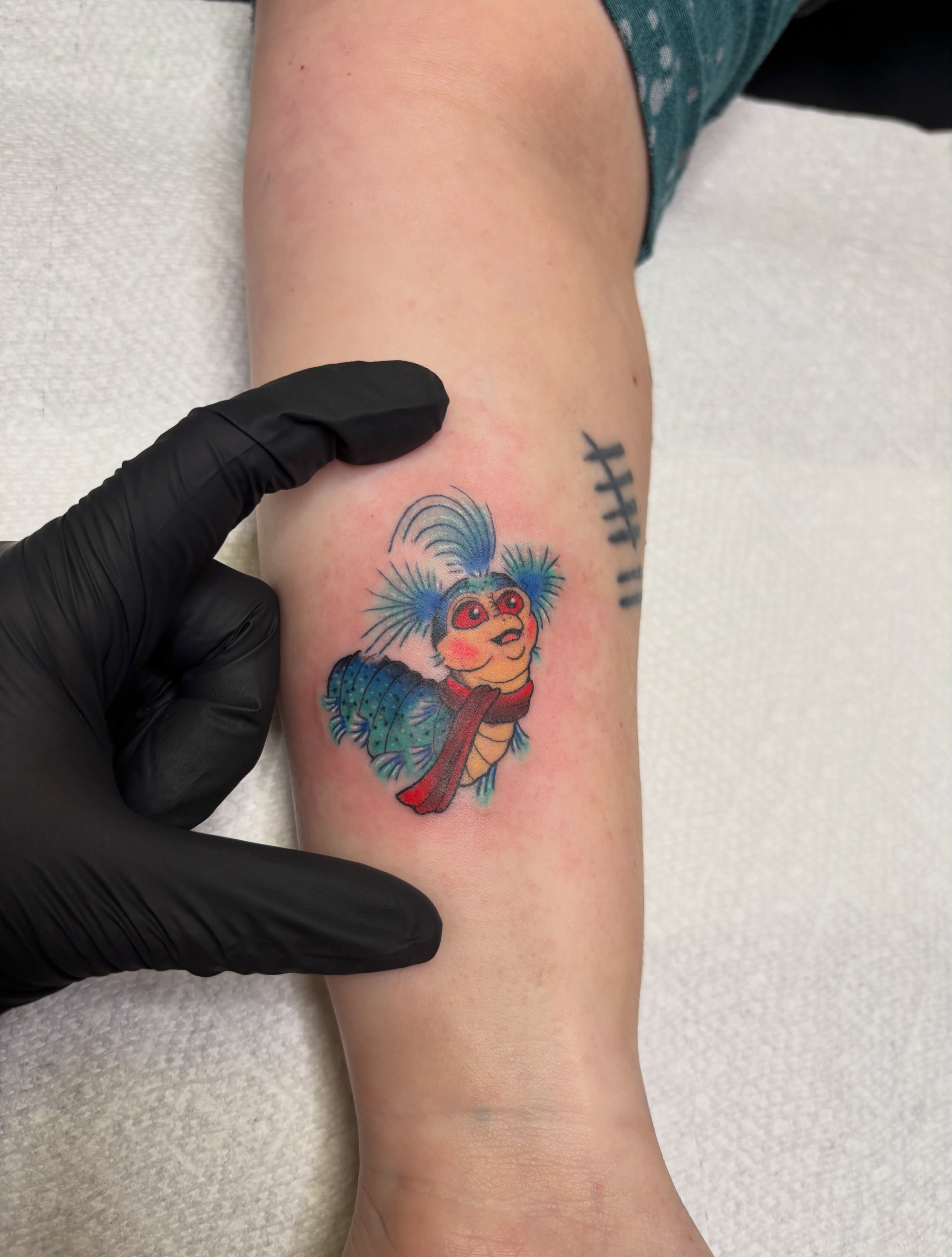 Owl illustrative tattoo on the forearm by MJ Saunders