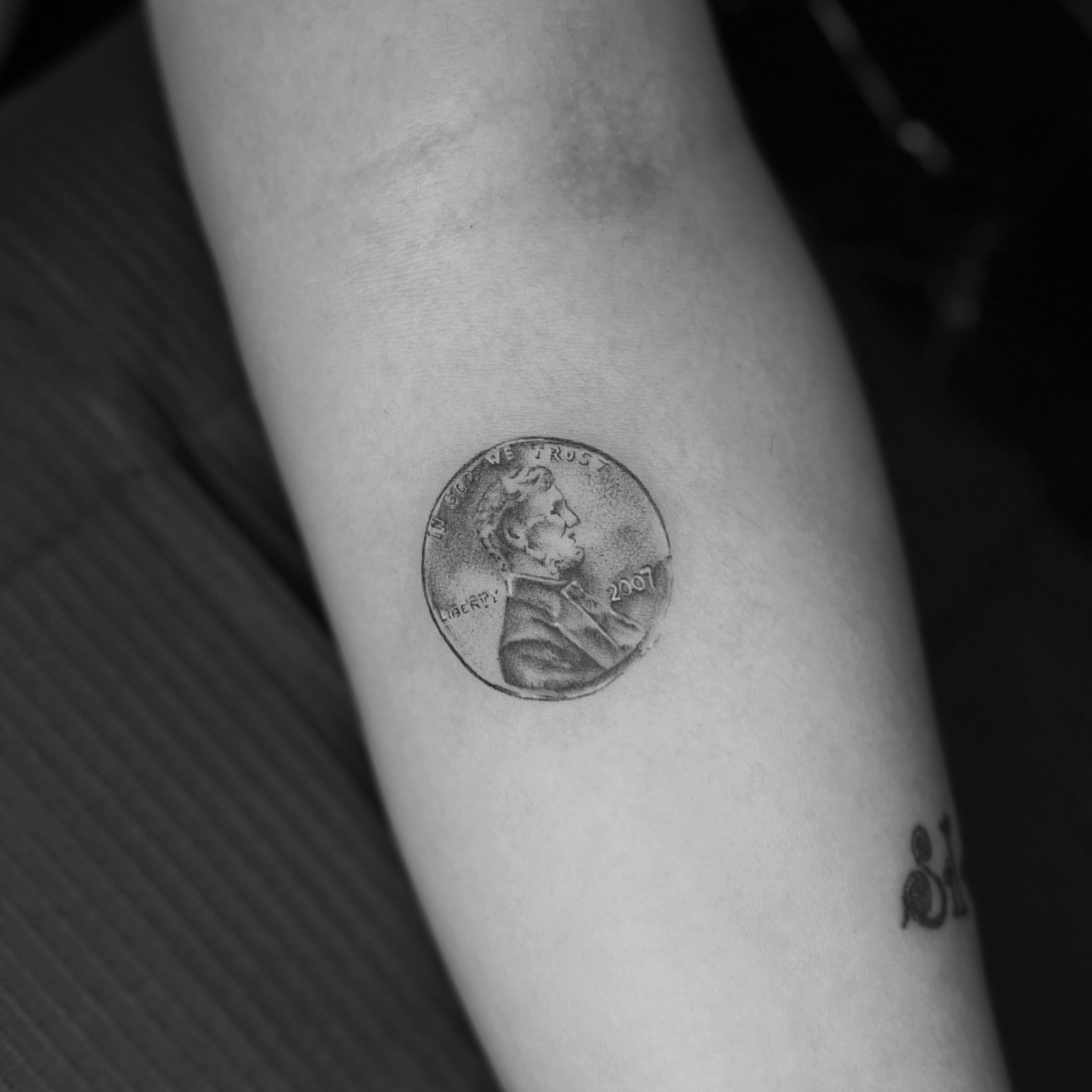 Dime black and grey tattoo on the forearm by Kait