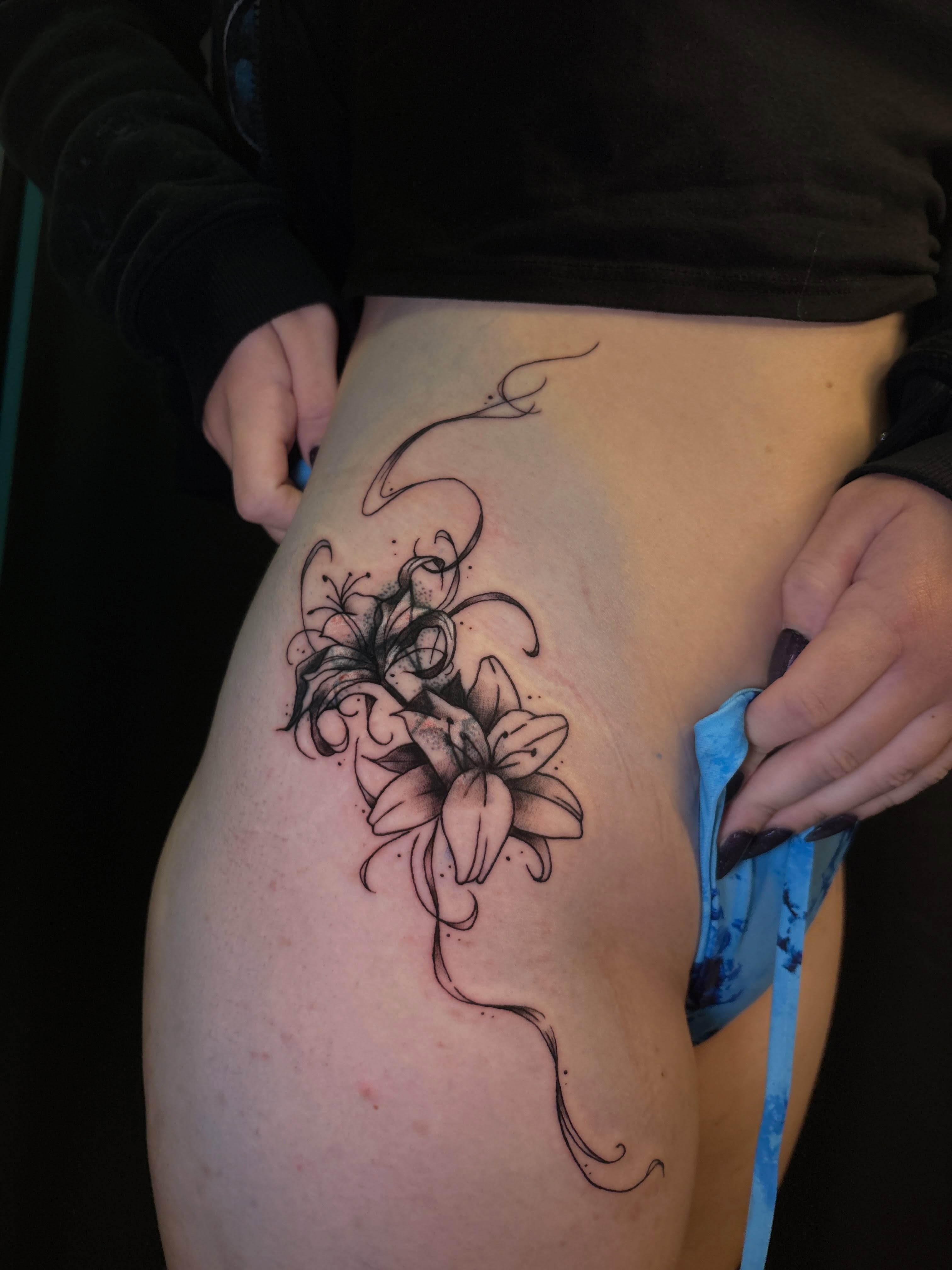 Lilies black and grey tattoo on the thigh by ⋆.˚ ☾ .⭒˚ alaina
