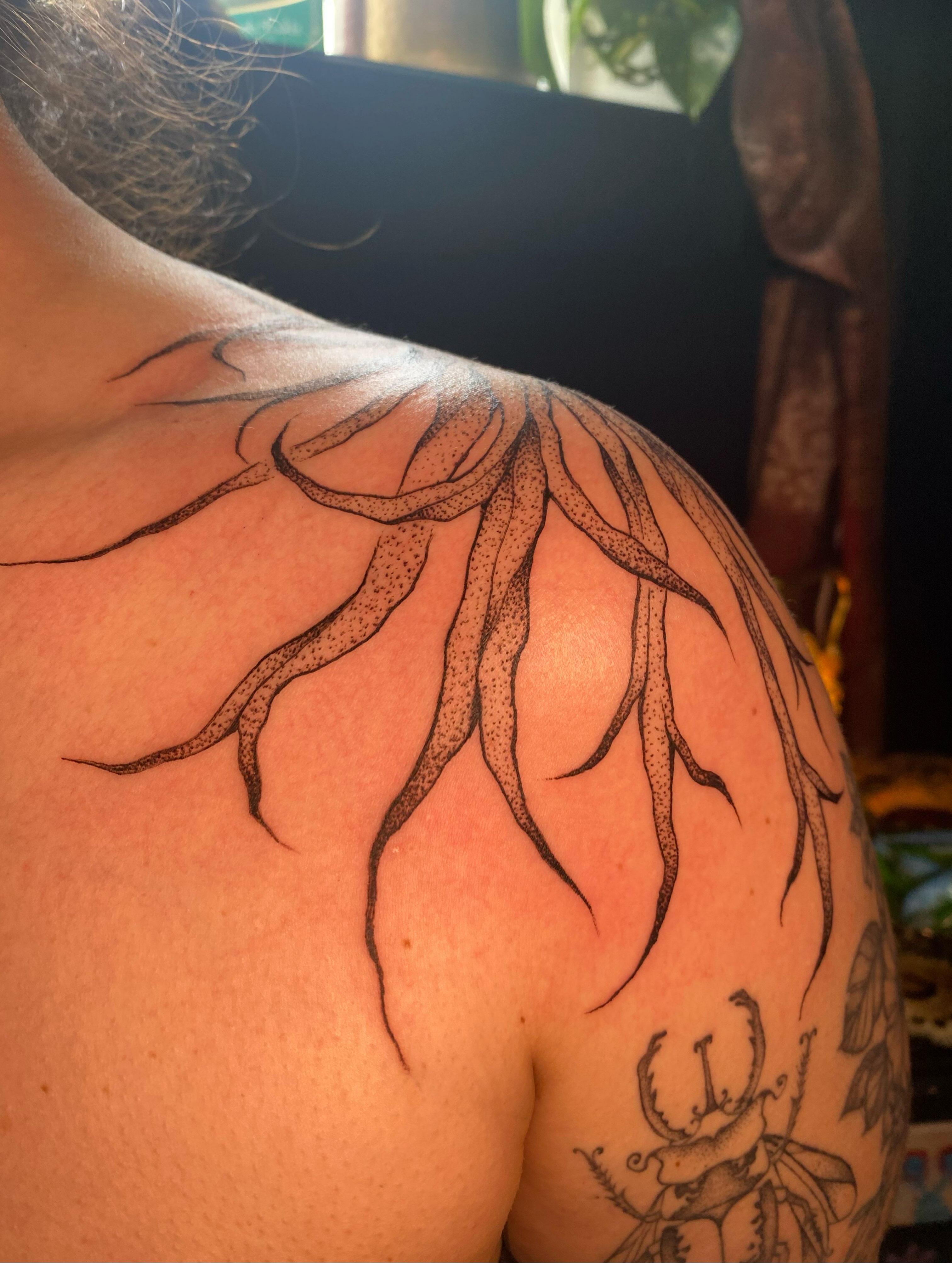 Octopus tentacles dotwork tattoo on the shoulder by Jesikah Rapp