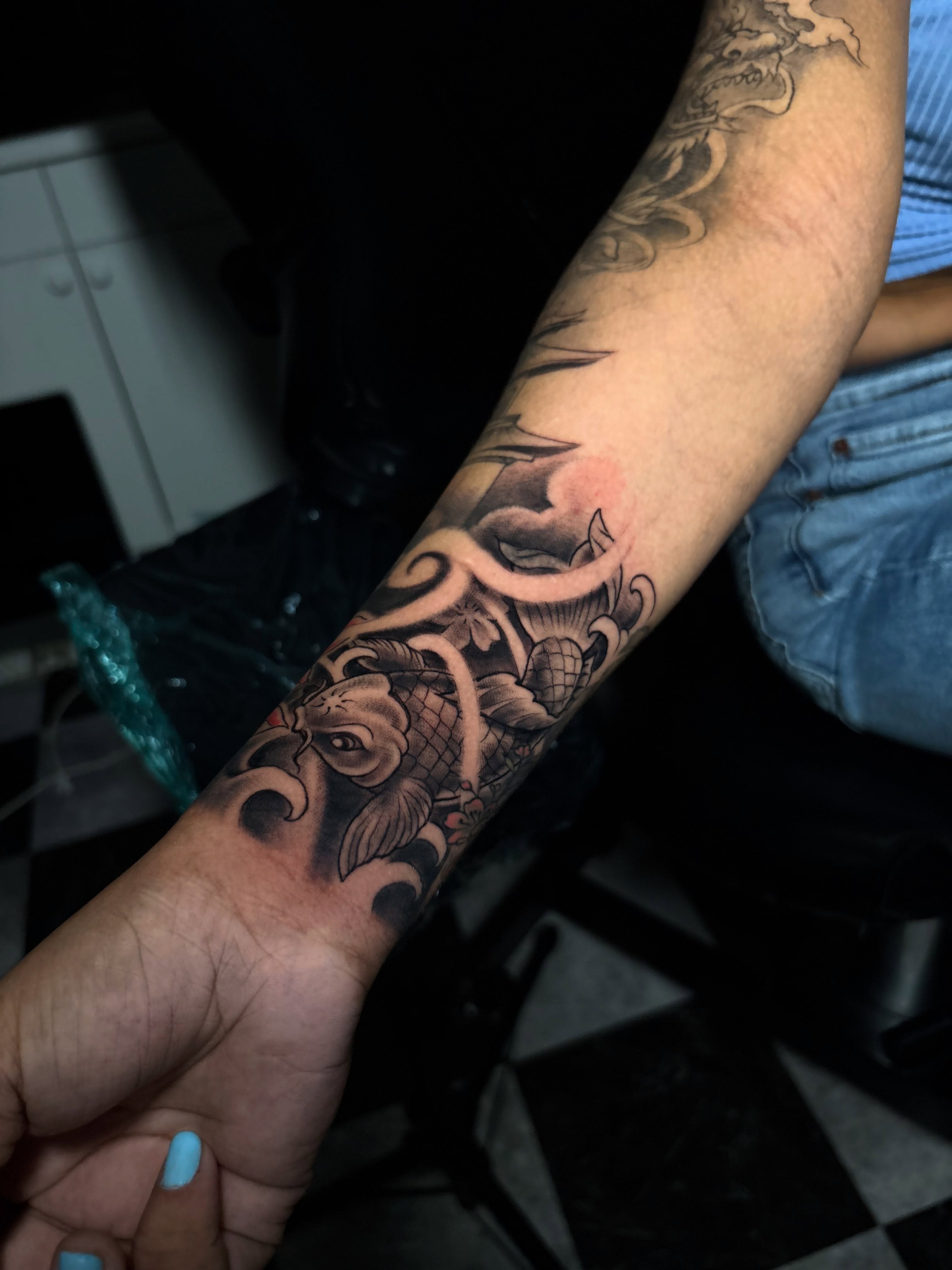 Koi fish japanese irezumi tattoo on the forearm by Nikko