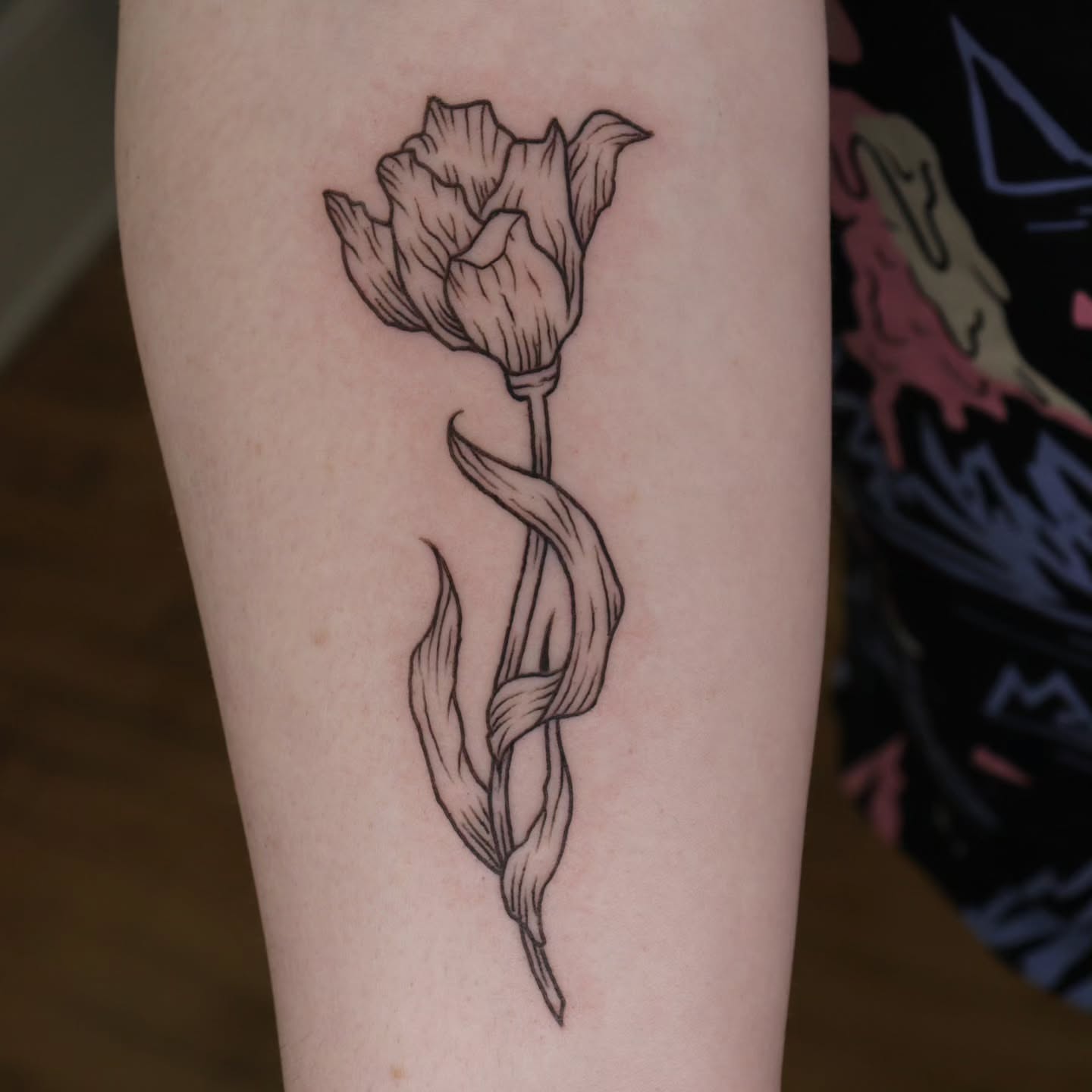 Tulip black and grey tattoo on the forearm by Veronika Lipchak