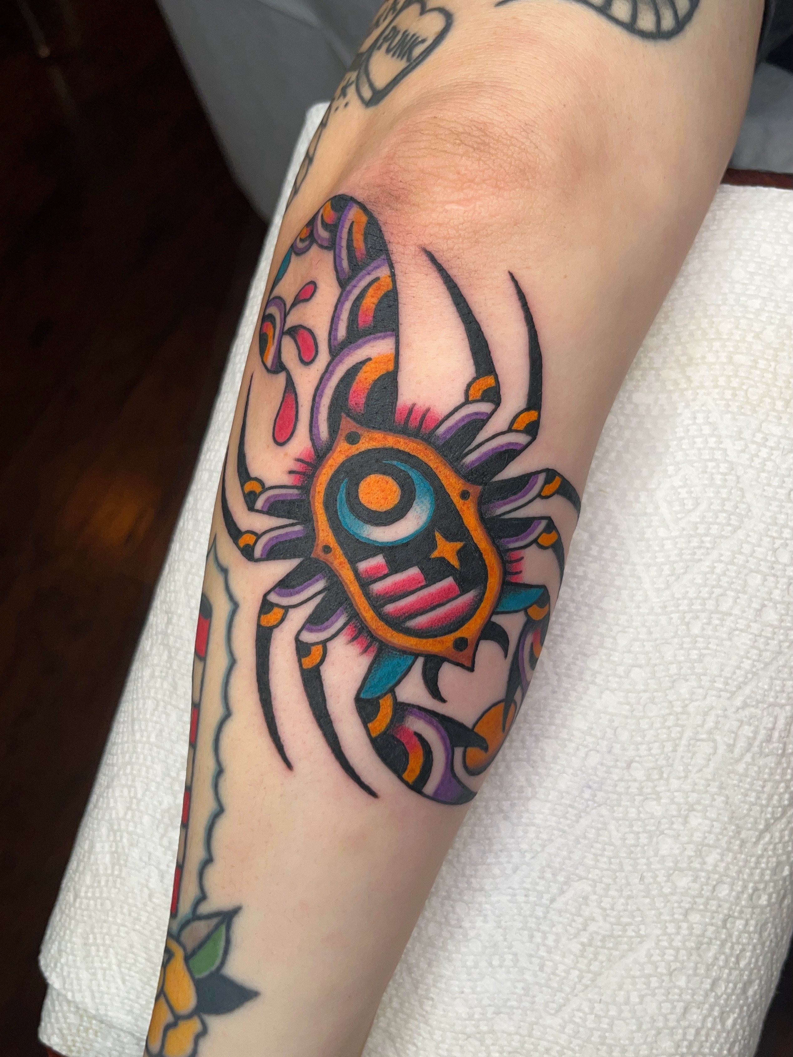 Spider American traditional tattoo on the forearm by Nat Power