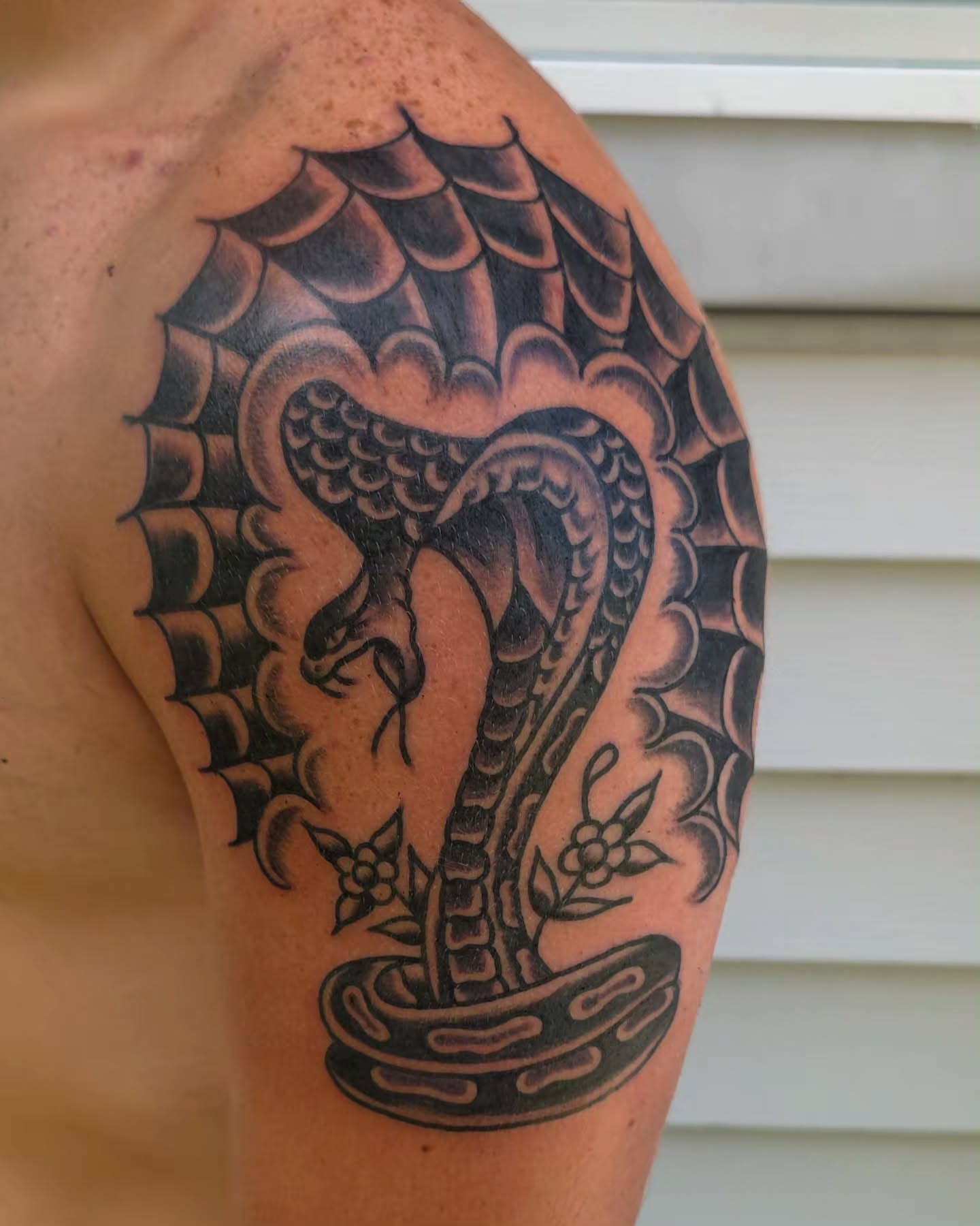Snake and flowers black and grey tattoo on the shoulder by J. Kirsch New Jersey Tattoo Artist