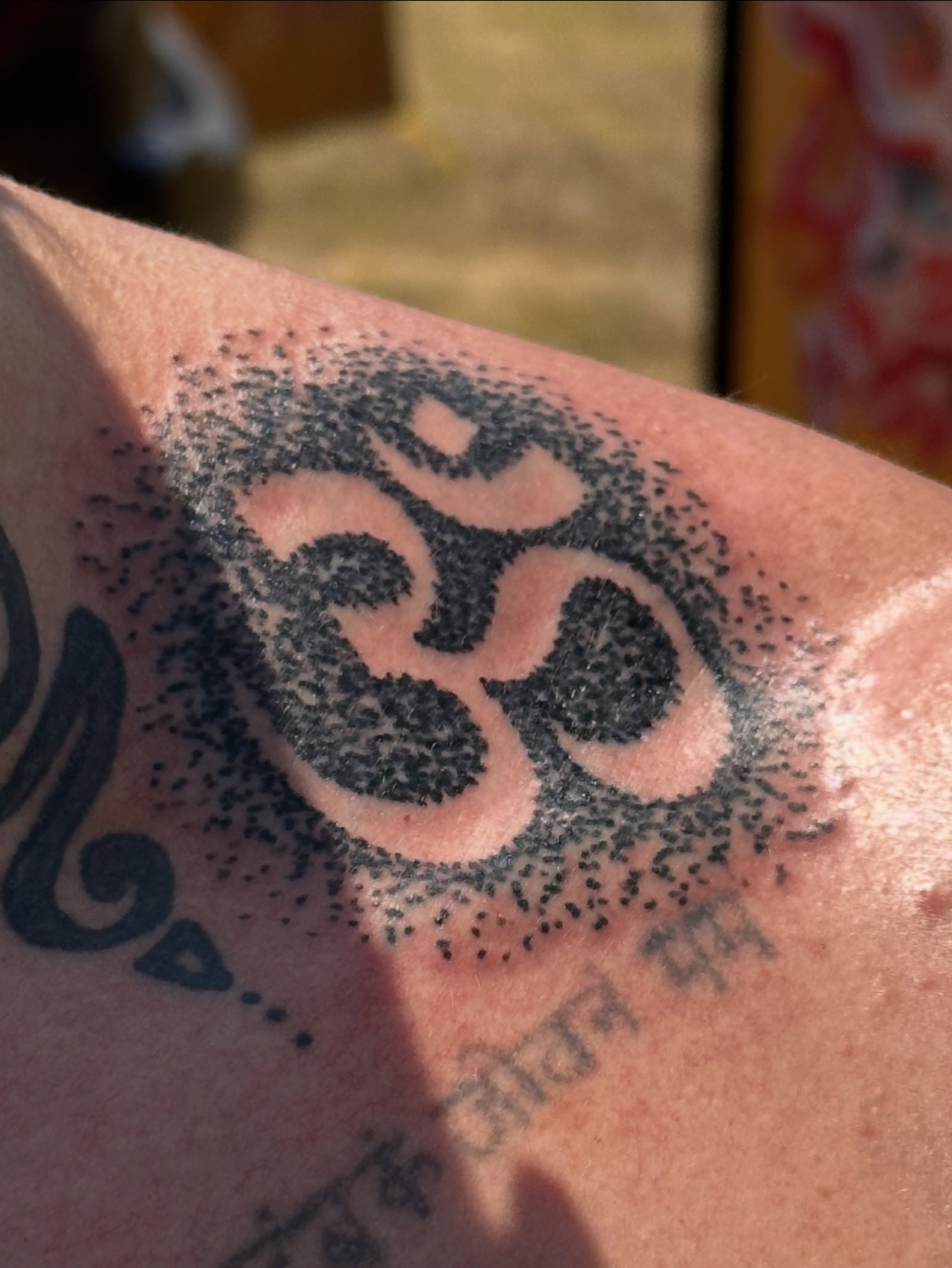 Om symbol dotwork tattoo on the upper arm by Gabriel F Kingston Beitia