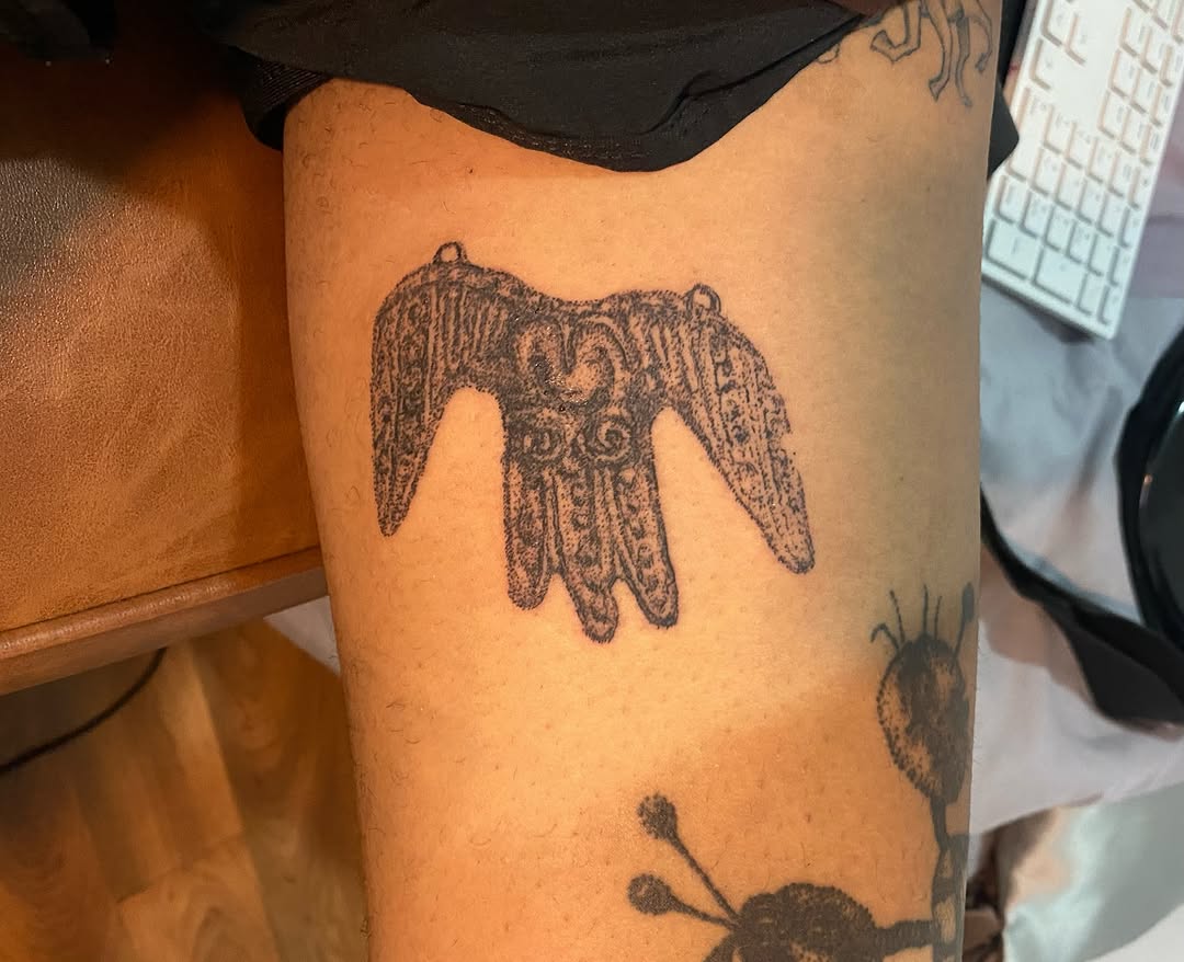 Winged hand amulet dotwork tattoo on the thigh by @feverfeverish