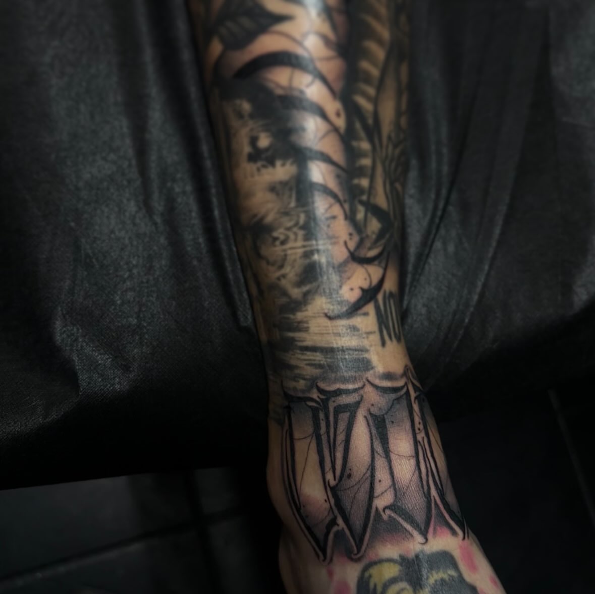 Tiger black and grey tattoo on the forearm by suzie