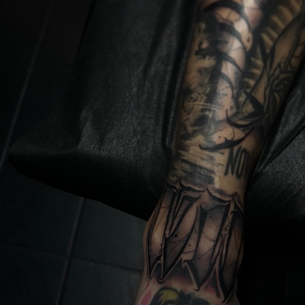 Bat wings black and grey tattoo on the forearm by suzie