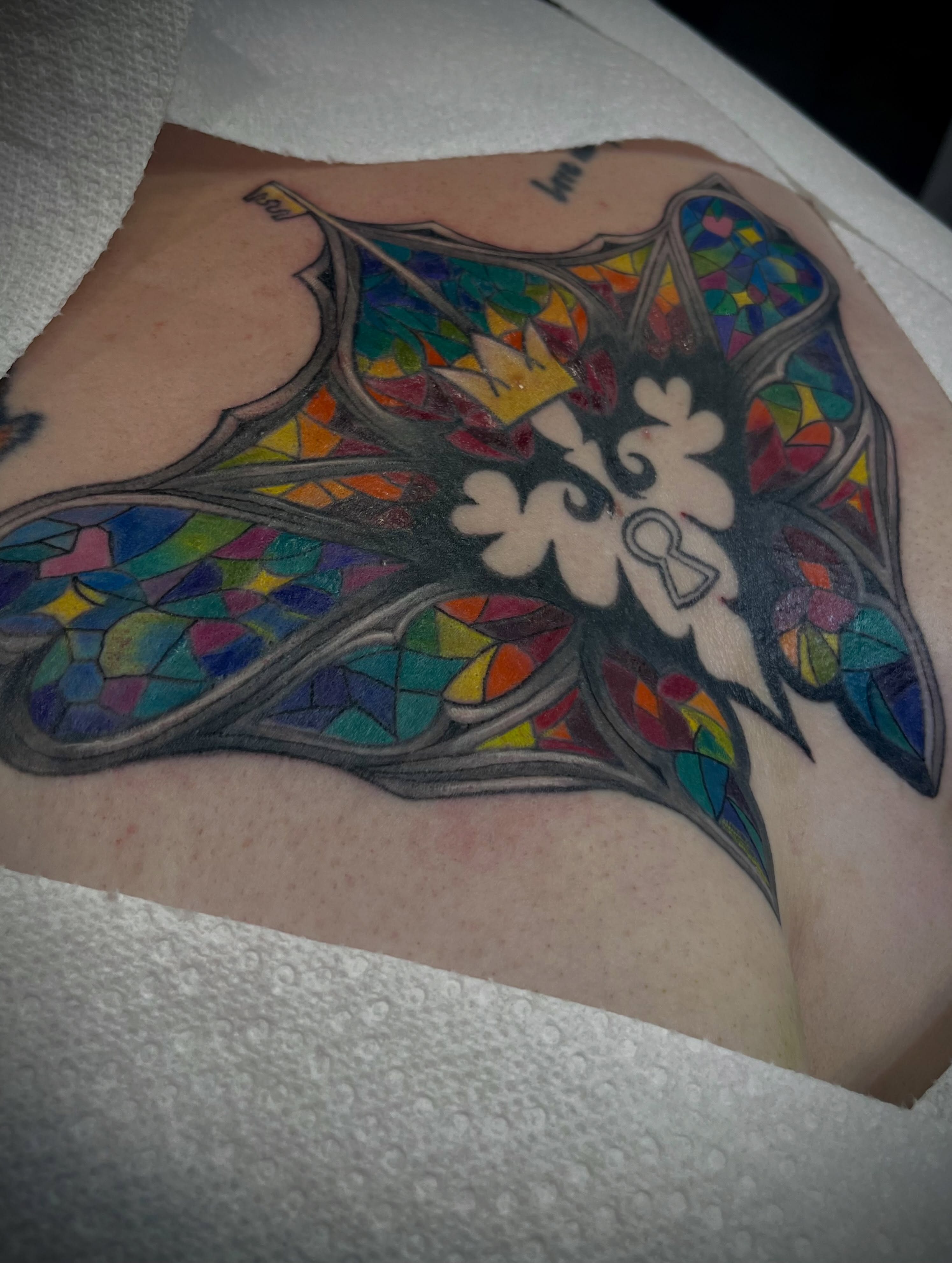 Stained glass window geometric tattoo on the thigh by Freya Petersen