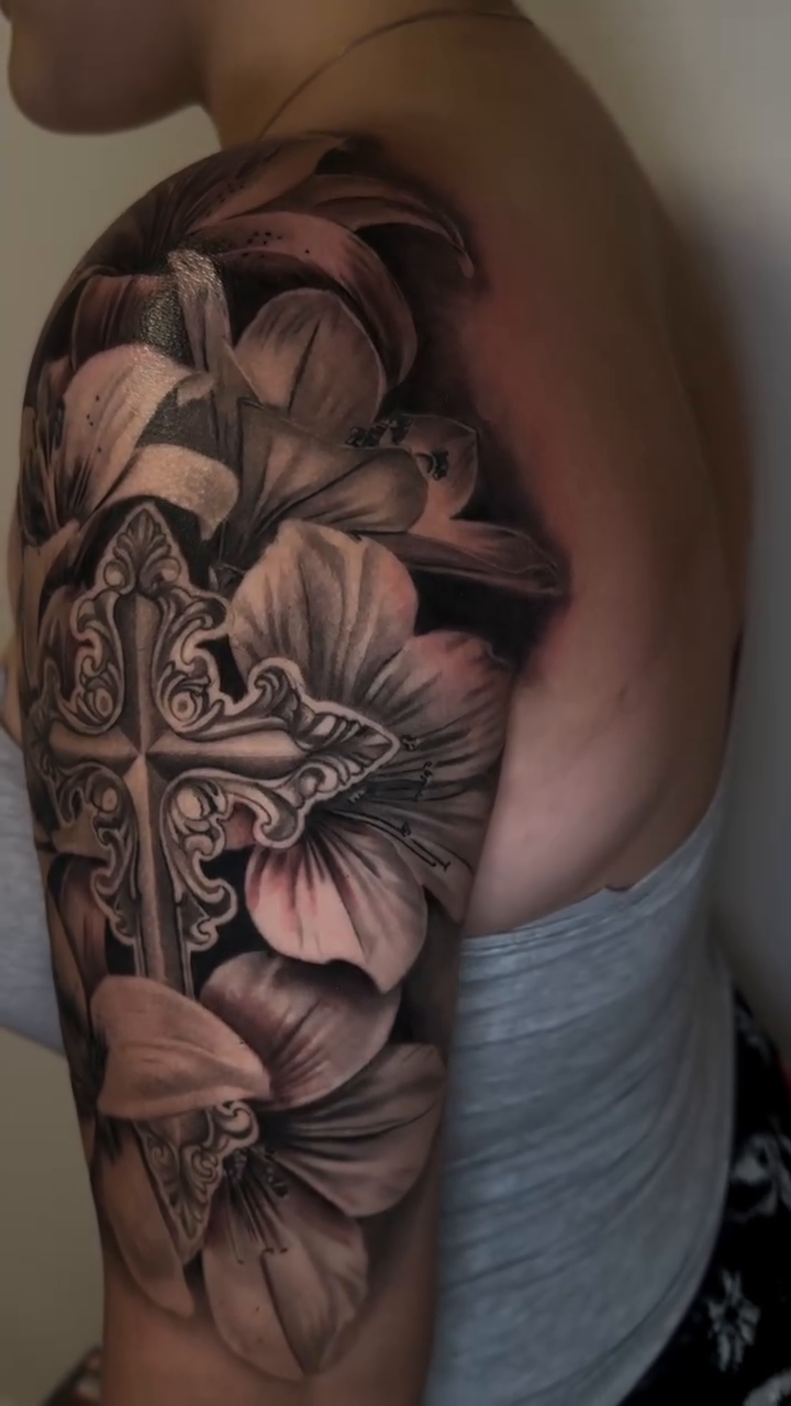 Cross and lilies realism tattoo by Tattoos By Kique
