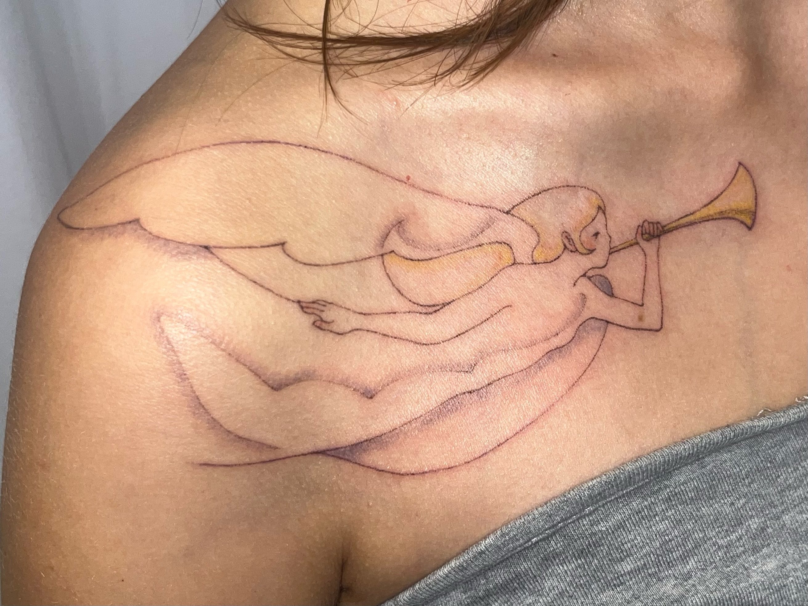 Angel playing trumpet fine line tattoo on the shoulder by 솝