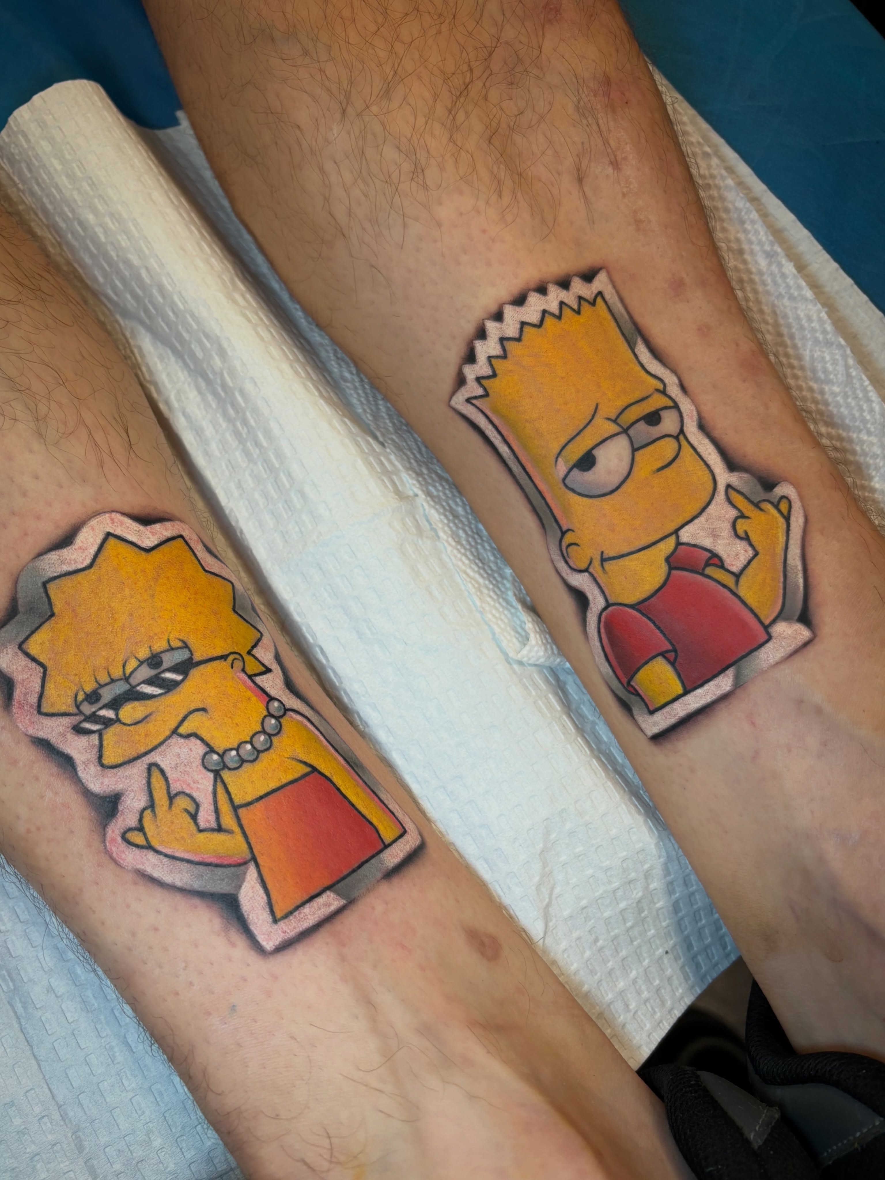 Simpsons characters illustrative tattoo on the forearm by Sam AlpineInk
