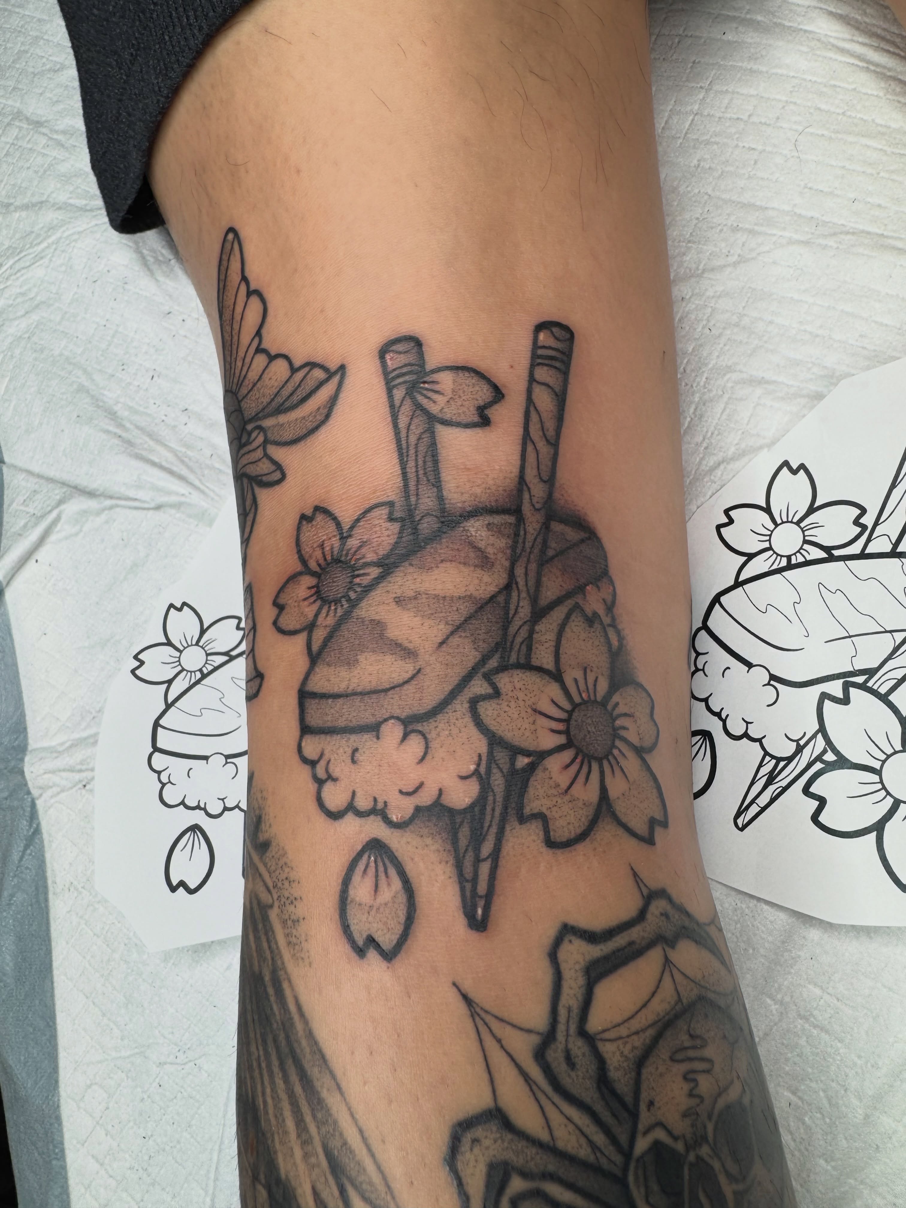 Heart and flowers black and grey tattoo on the forearm by Donnie Moore