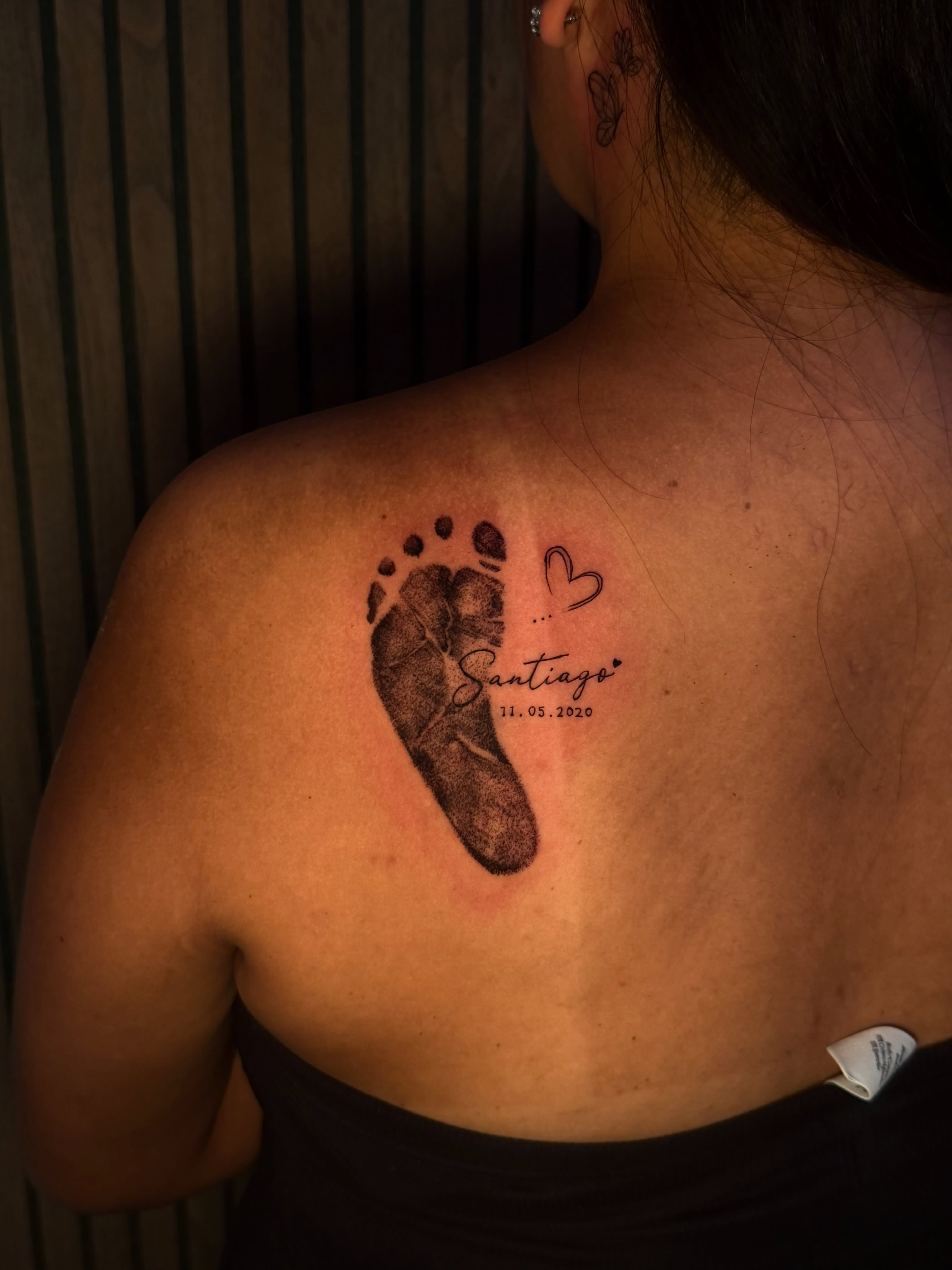 Footprint with name and date dotwork tattoo on the back by Sebastian martinez, Memphis, Tennessee