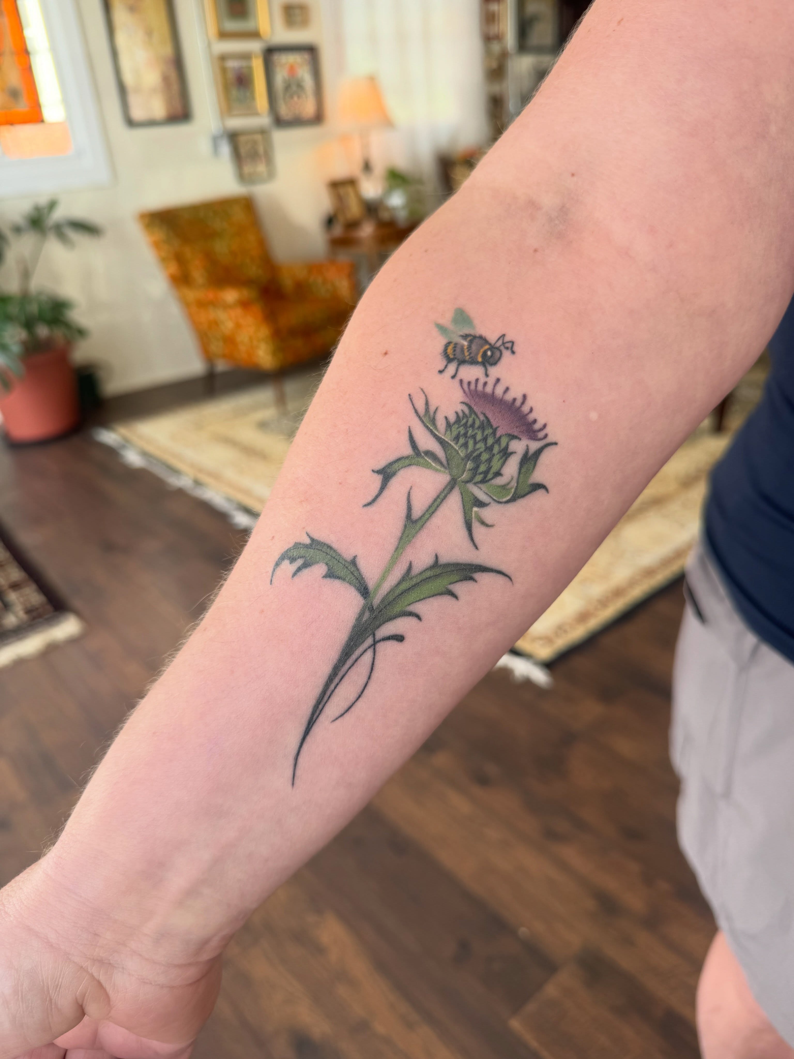 Thistle with bee realism tattoo on the forearm by Alisa (Li) Affatato ๐ผ