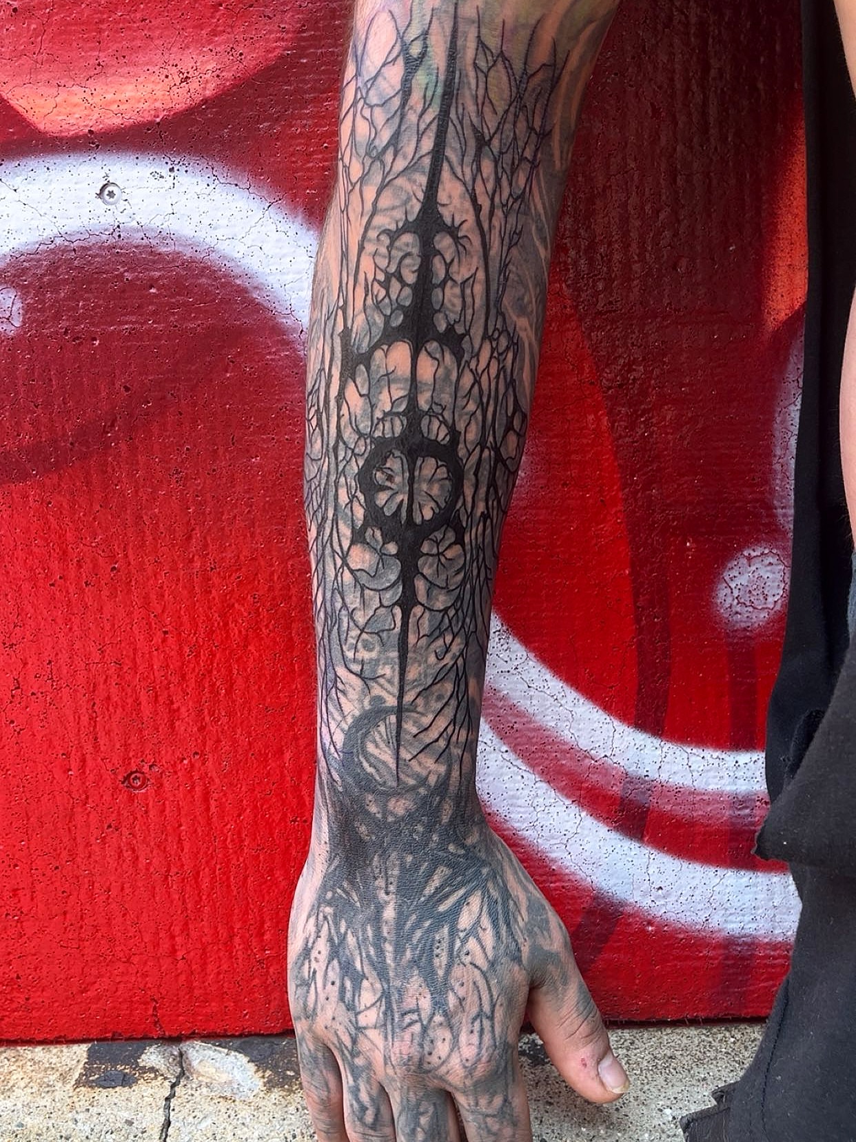 Root system black and grey tattoo on the forearm by Elle Miller