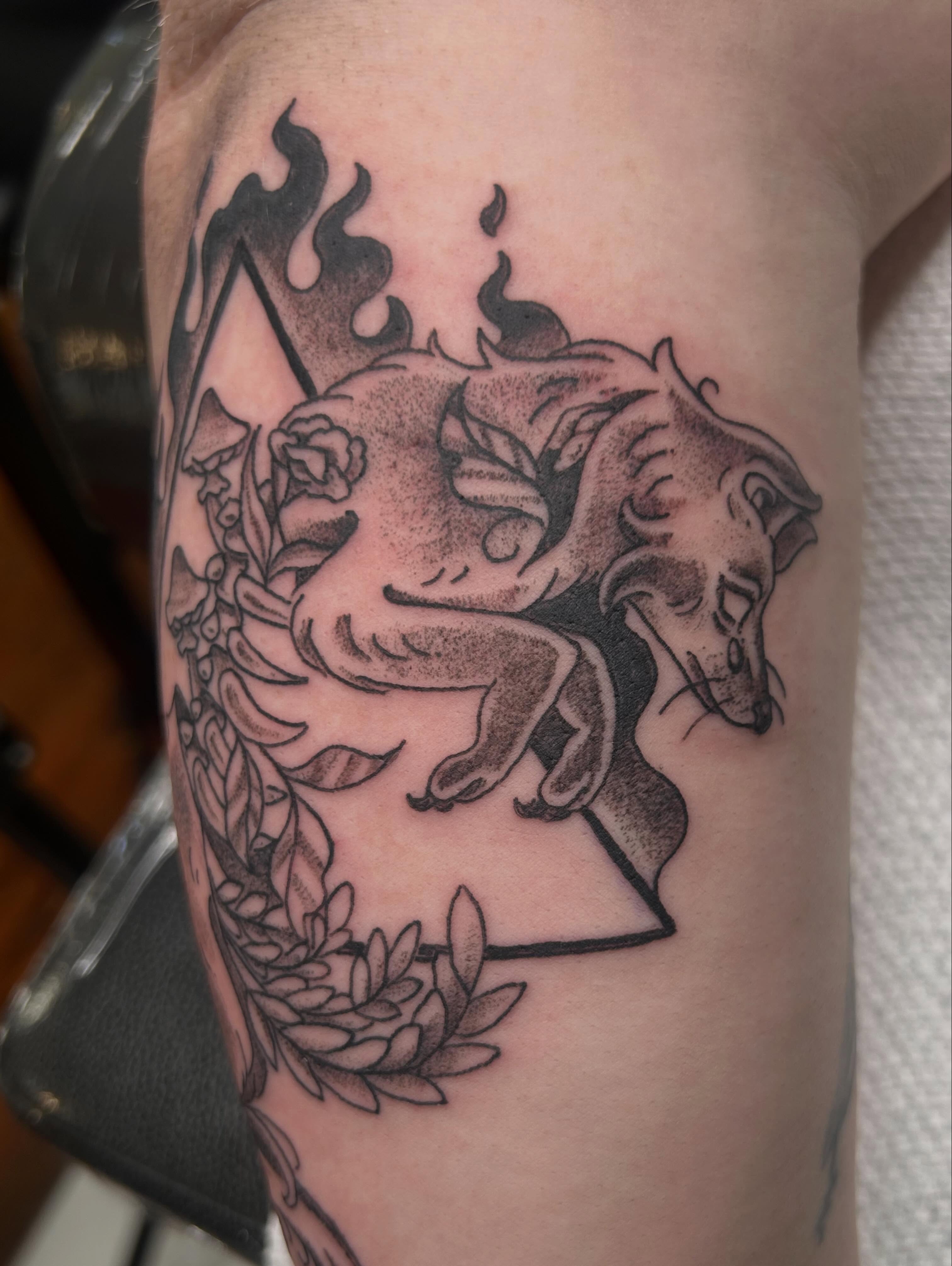 Dragon and roses black and grey tattoo on the forearm by Reilley Earles