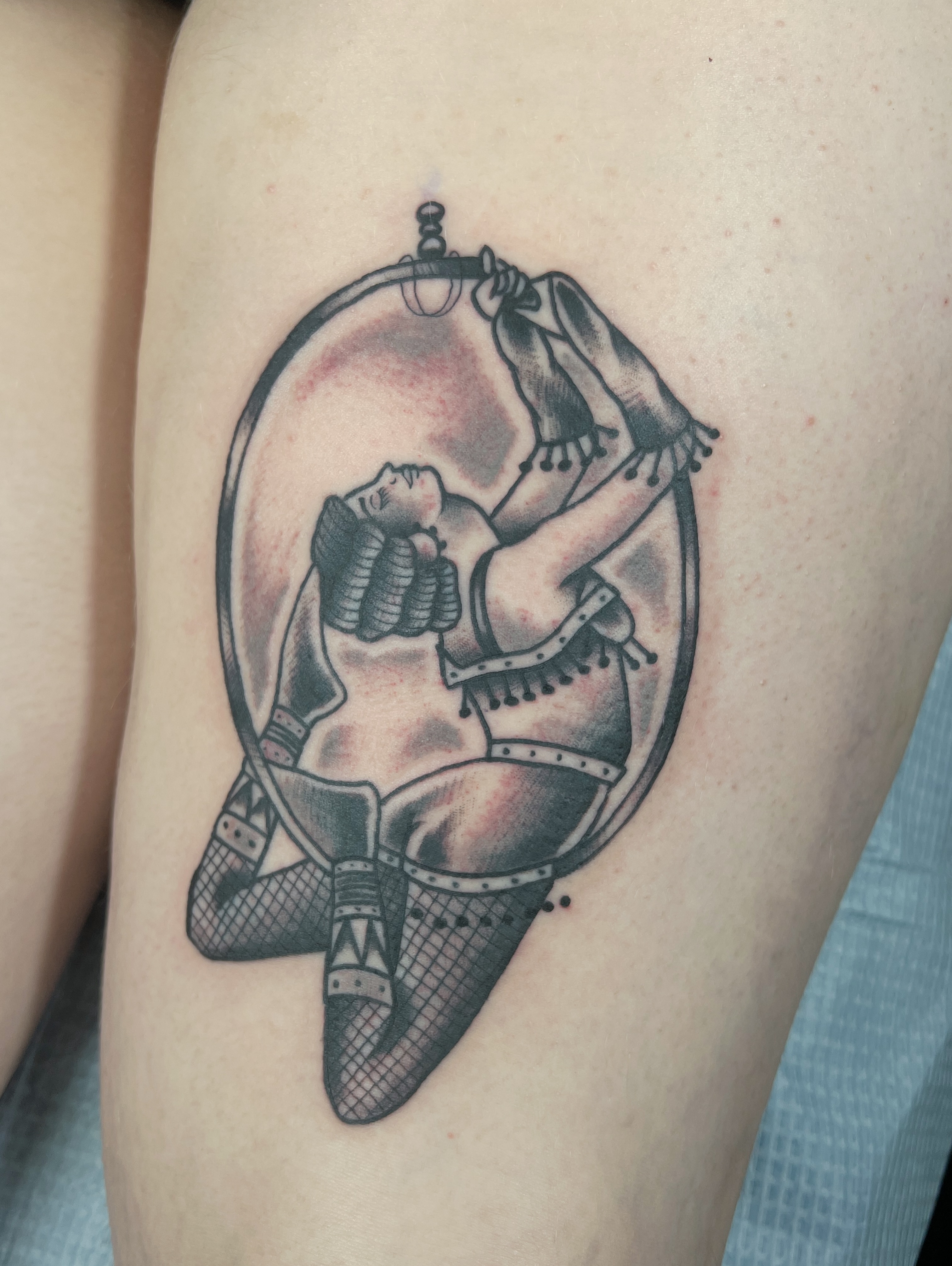 Female acrobat American traditional tattoo on the thigh by Brian Mock