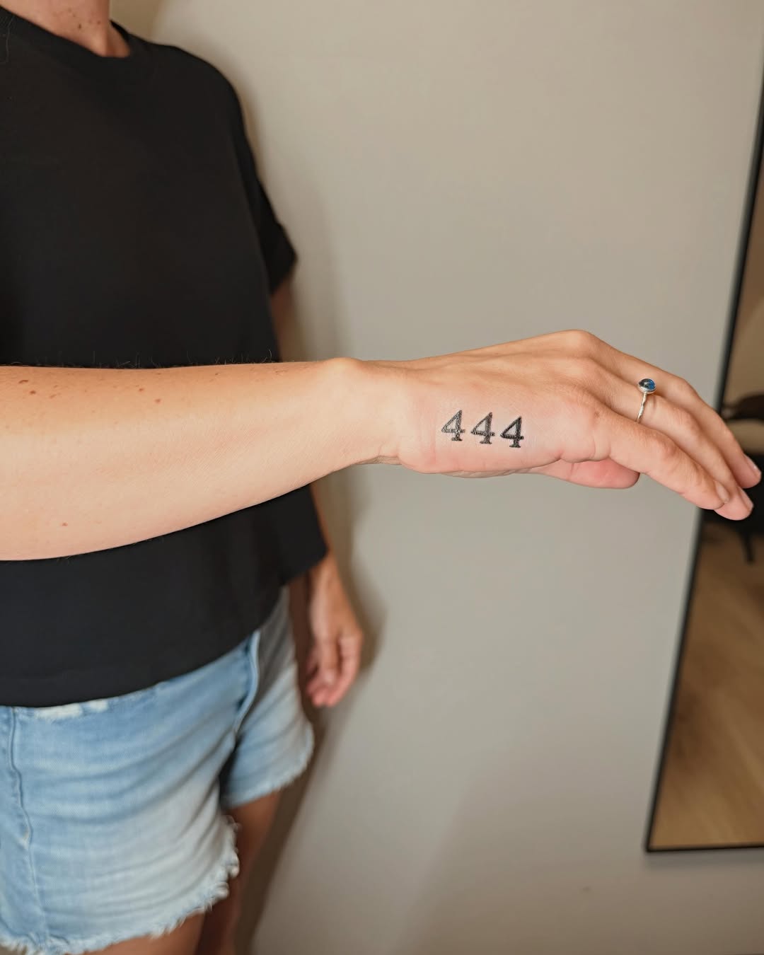 Number 444 lettering script tattoo on the forearm by Ashlee Burkey