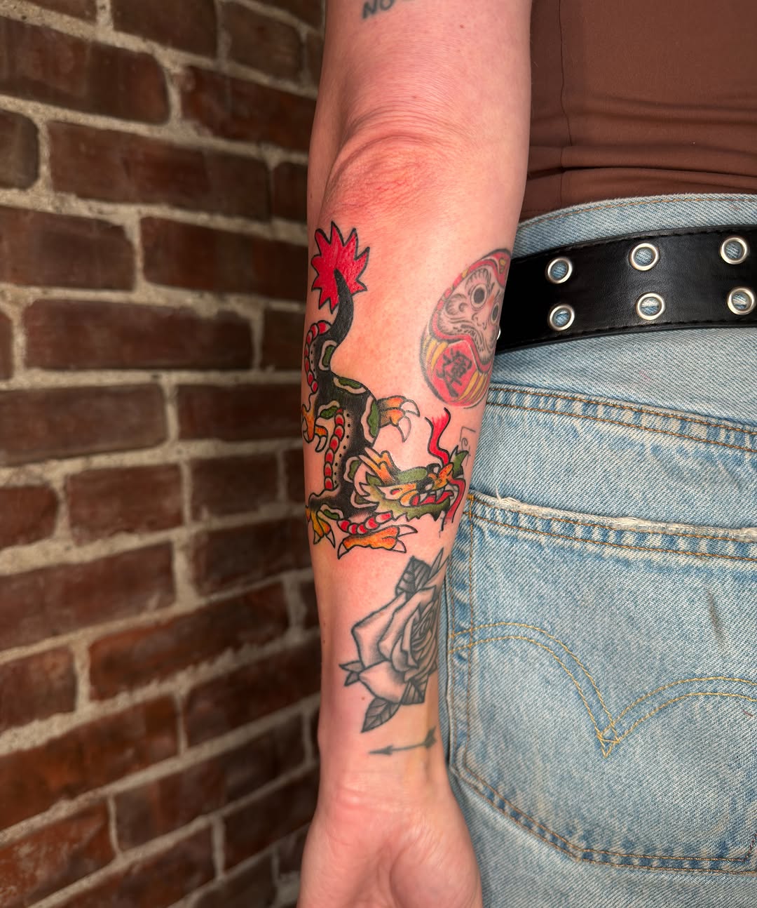 Dragon and flower American traditional tattoo on the forearm by Dennis Patterson