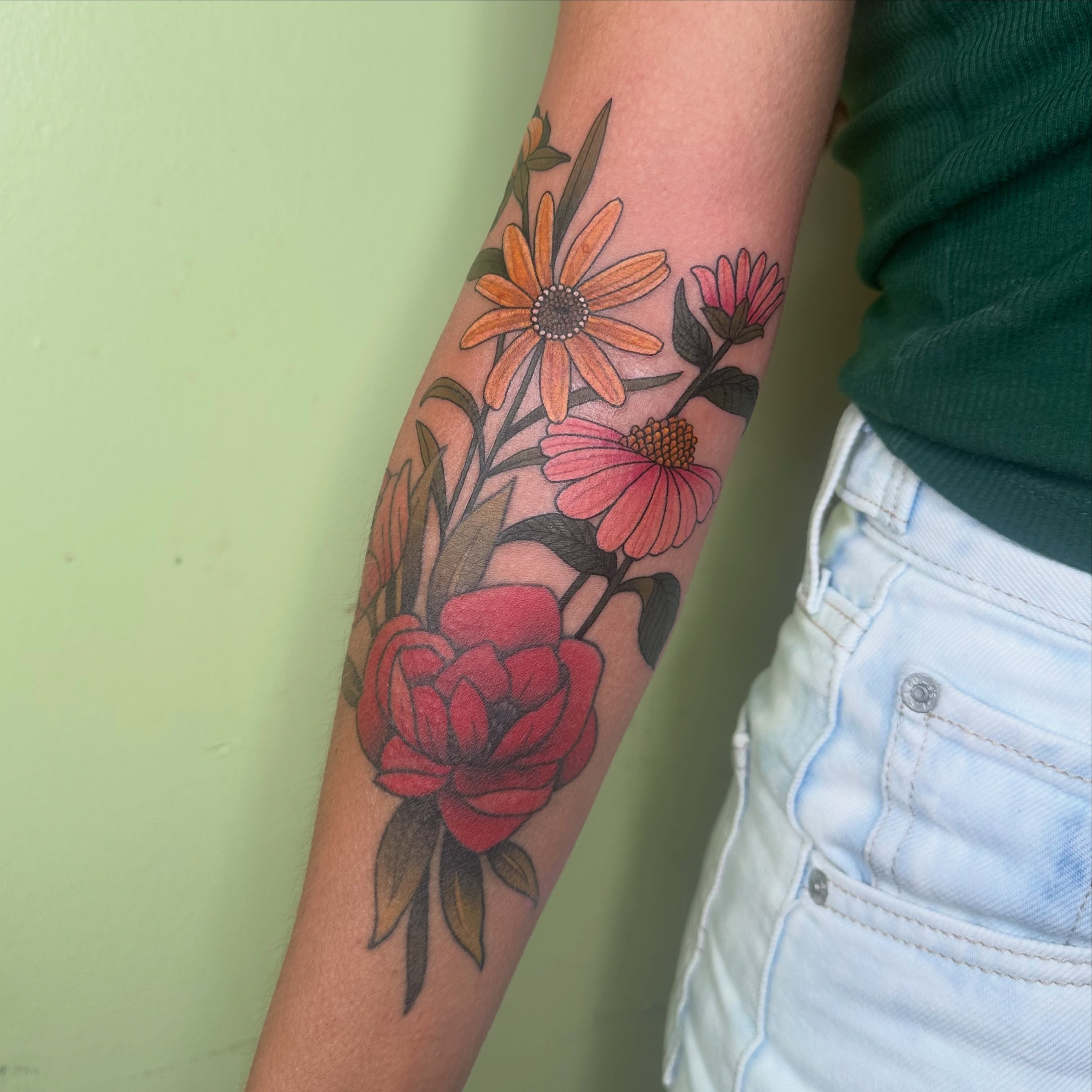 Floral arrangement realism tattoo on the forearm by Brieana Smith