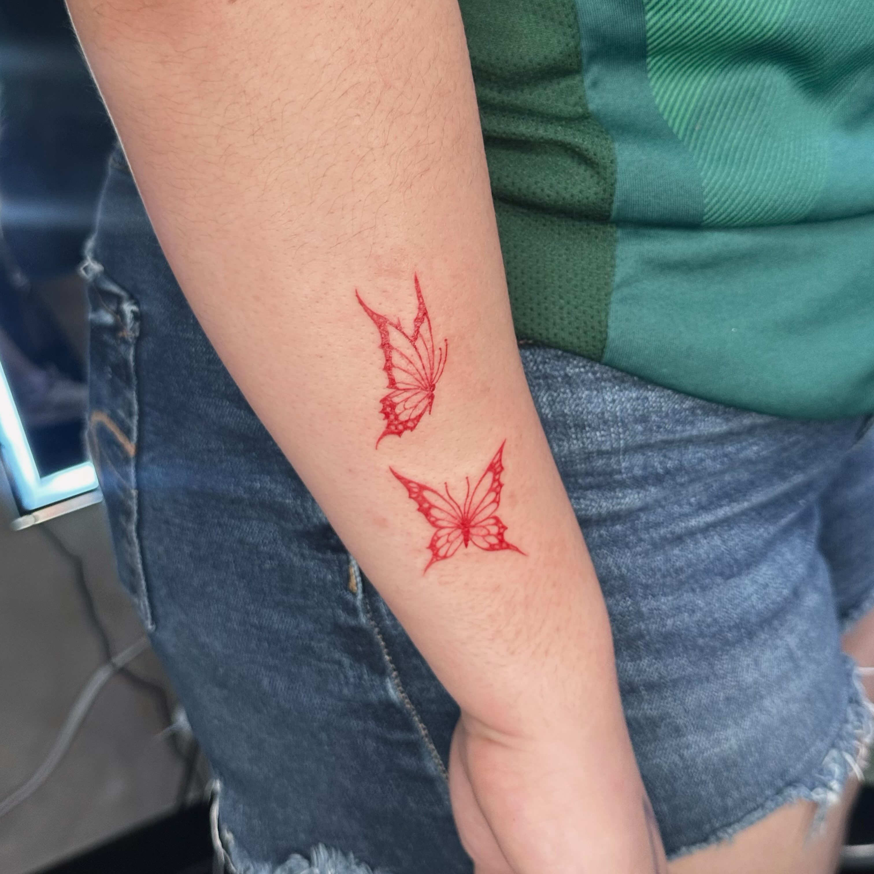 Butterflies geometric tattoo on the forearm by Liv