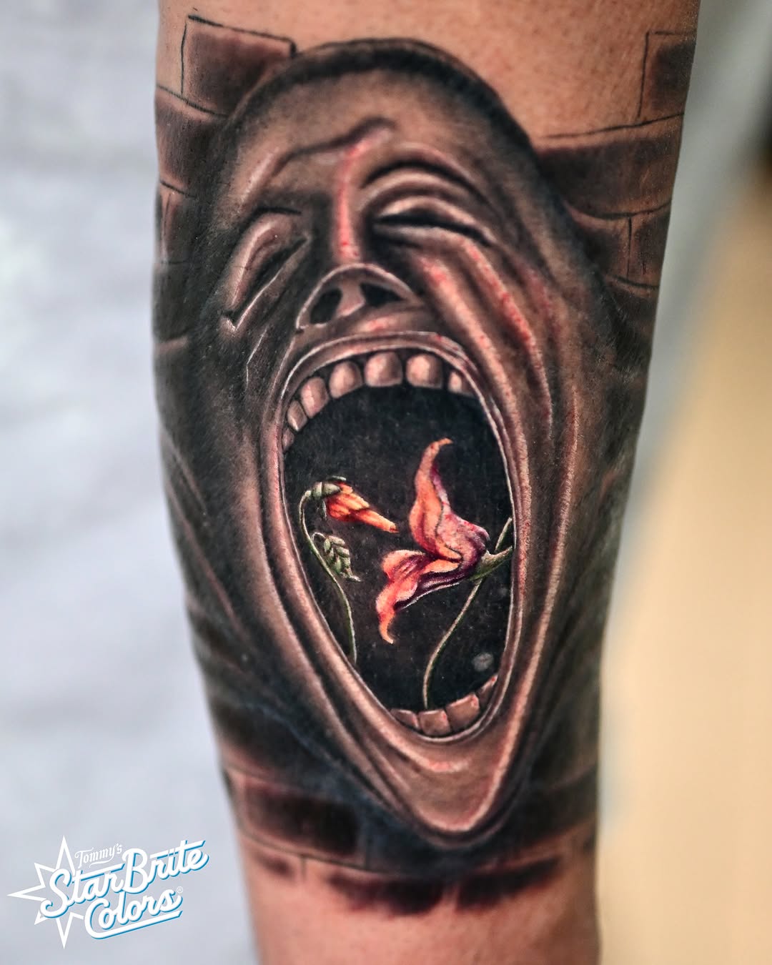 Scream with flower realism tattoo on the forearm by Sean OHara