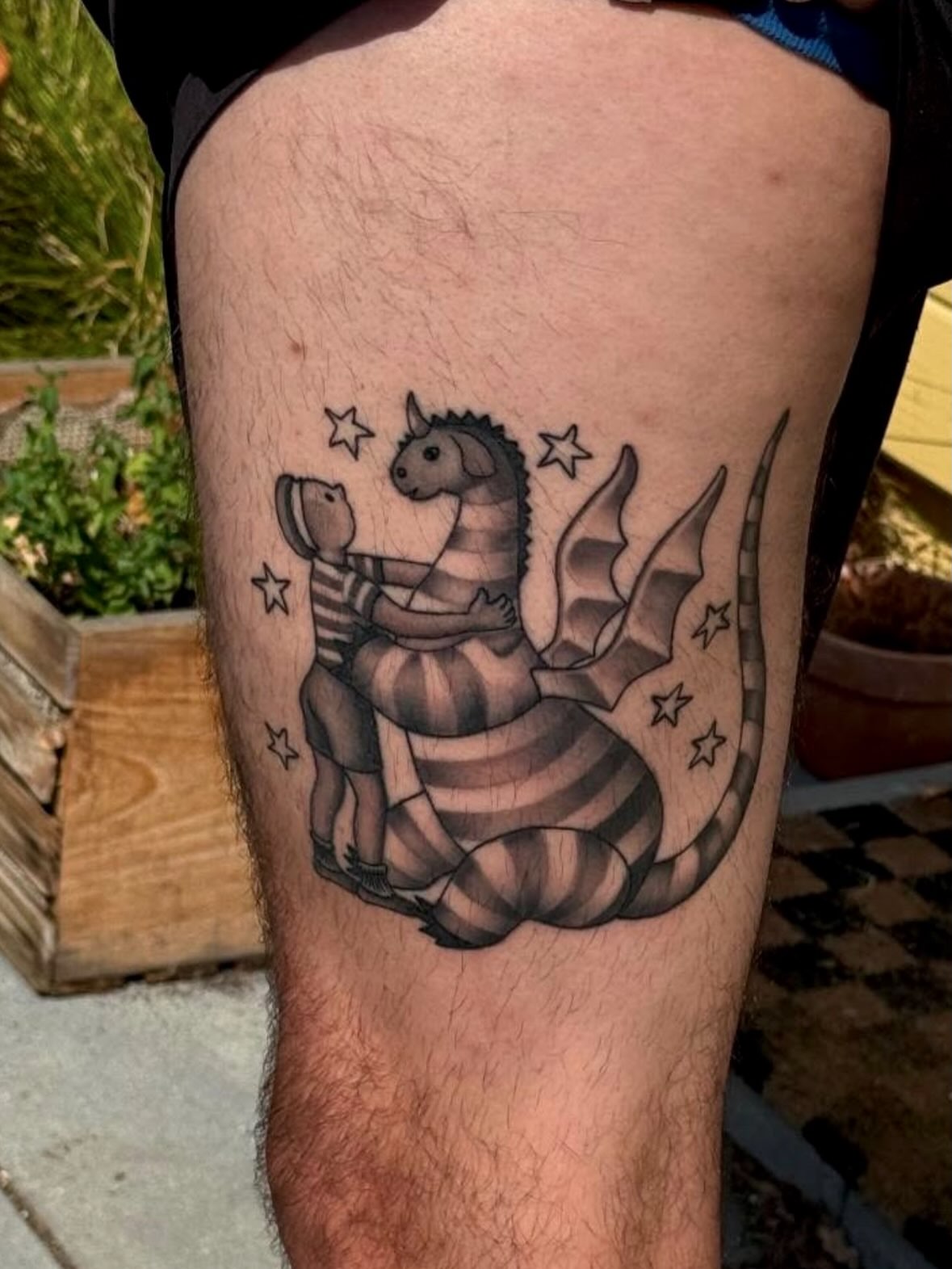 Child riding dragon black and grey tattoo on the thigh by Alyssa L'Heureux🕴🏼, Los Angeles, California