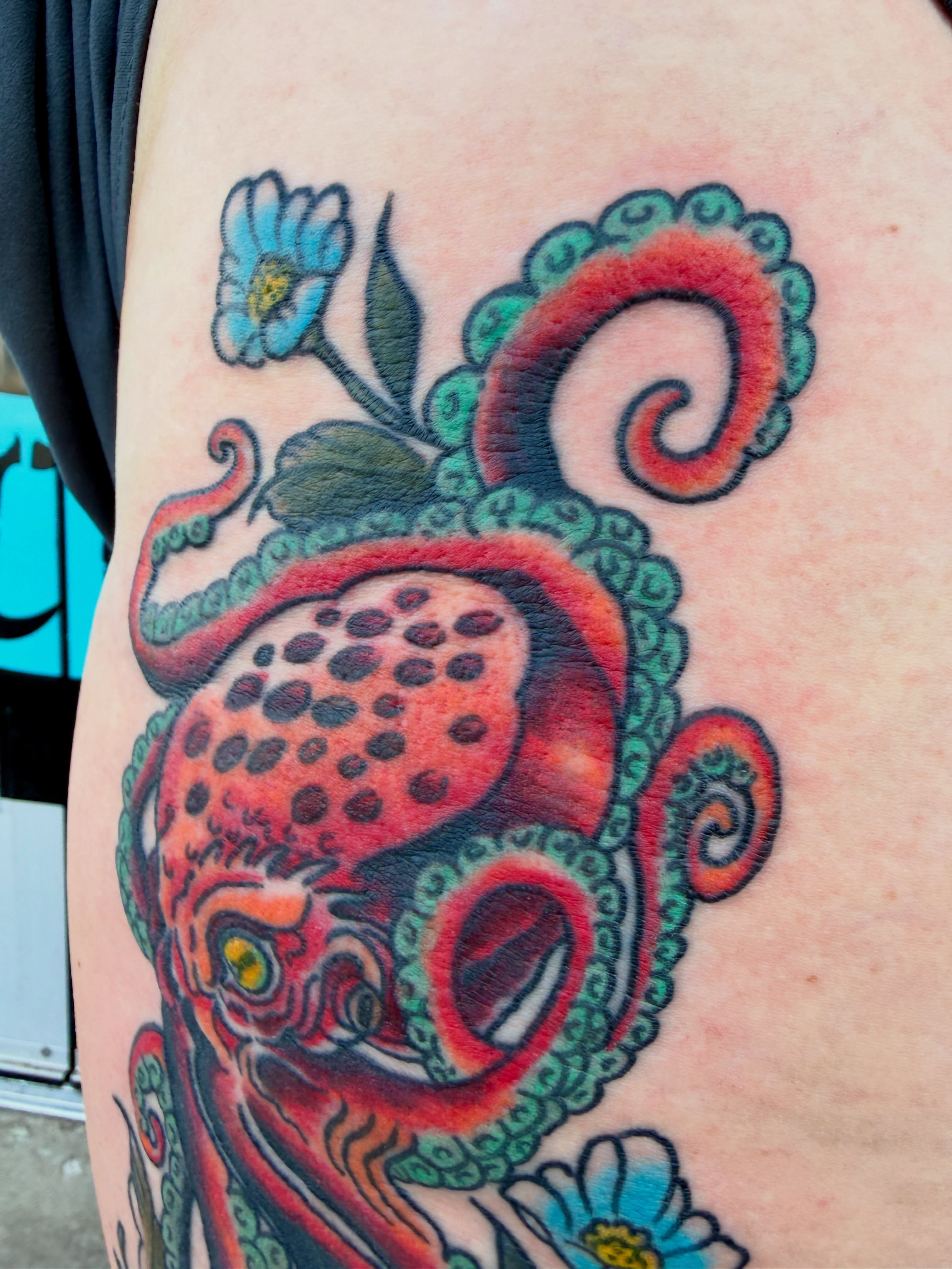 Octopus and flower American traditional tattoo on the thigh by Ali Calis