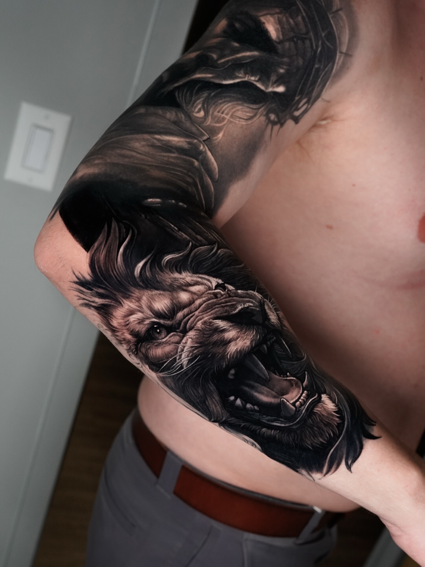 Roaring lion realism tattoo on the upper arm by Kasey Gonzalez, Bel Air, Maryland
