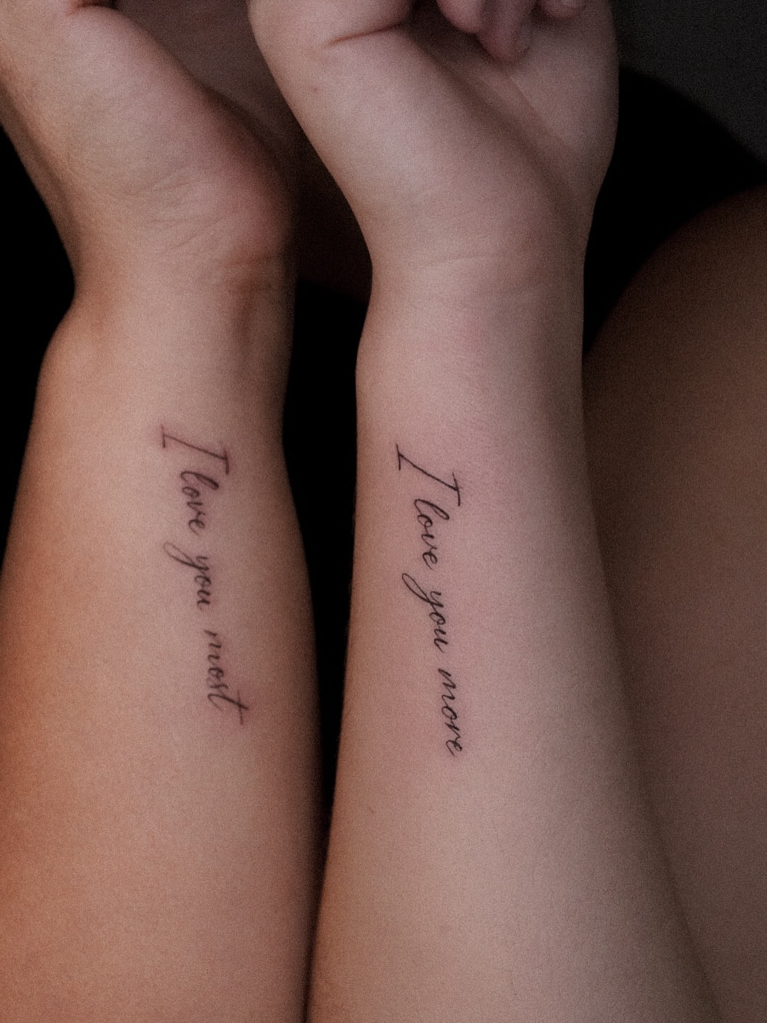 I love you more lettering script tattoo on the forearm by Joy Christiana