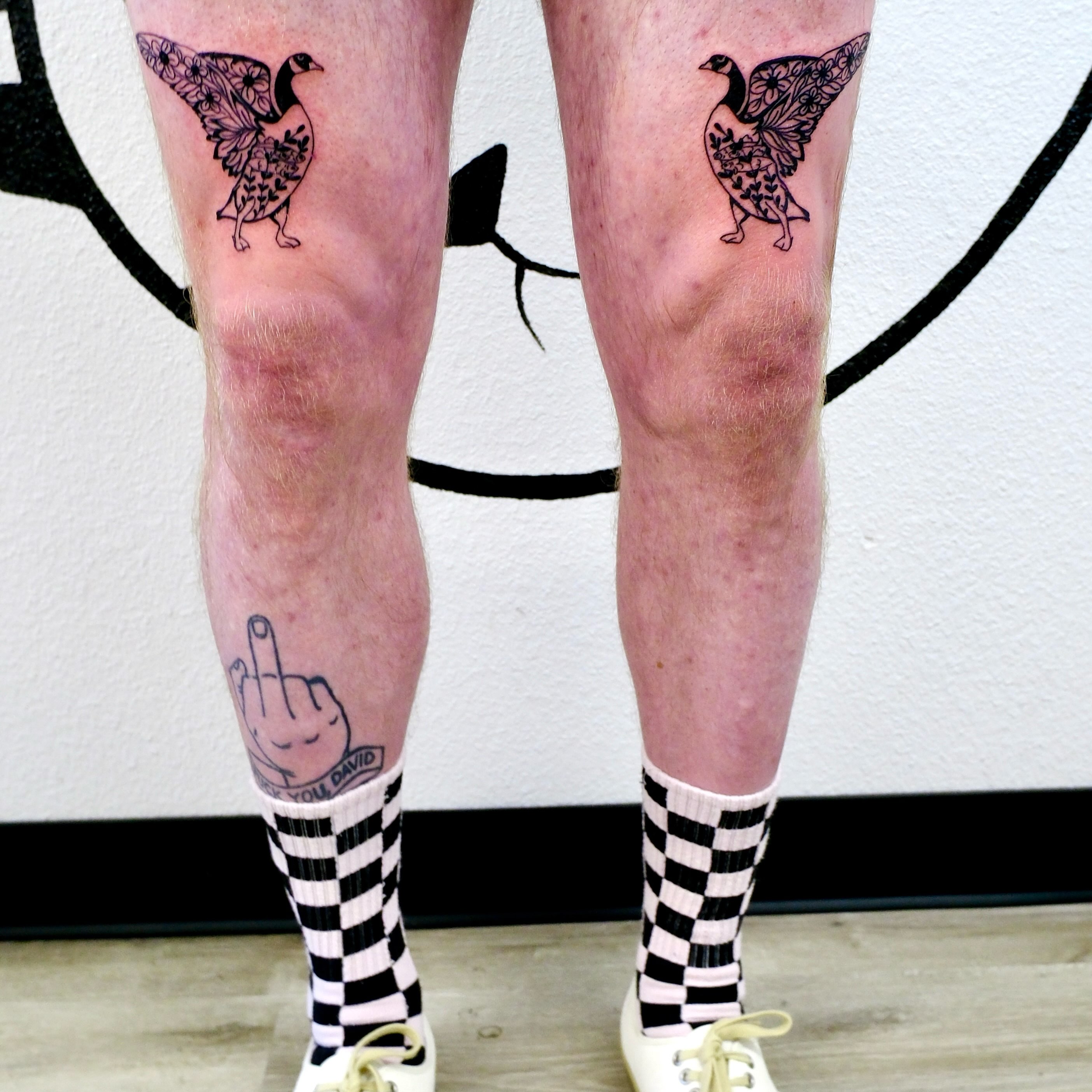 Goose with floral wings black and grey tattoo on the leg by Peggy
