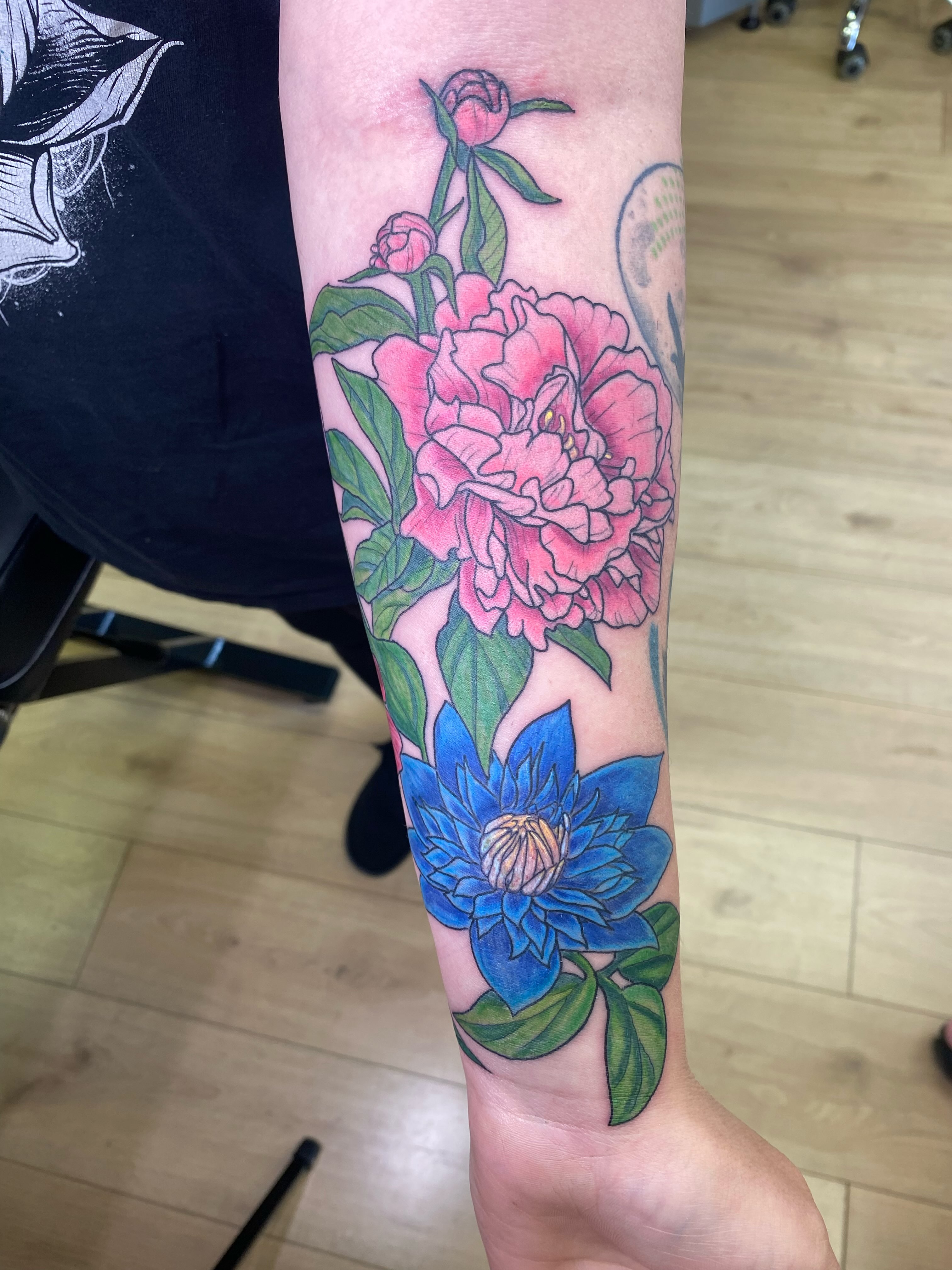 Peony and lotus realism tattoo on the forearm by Katie Leeper