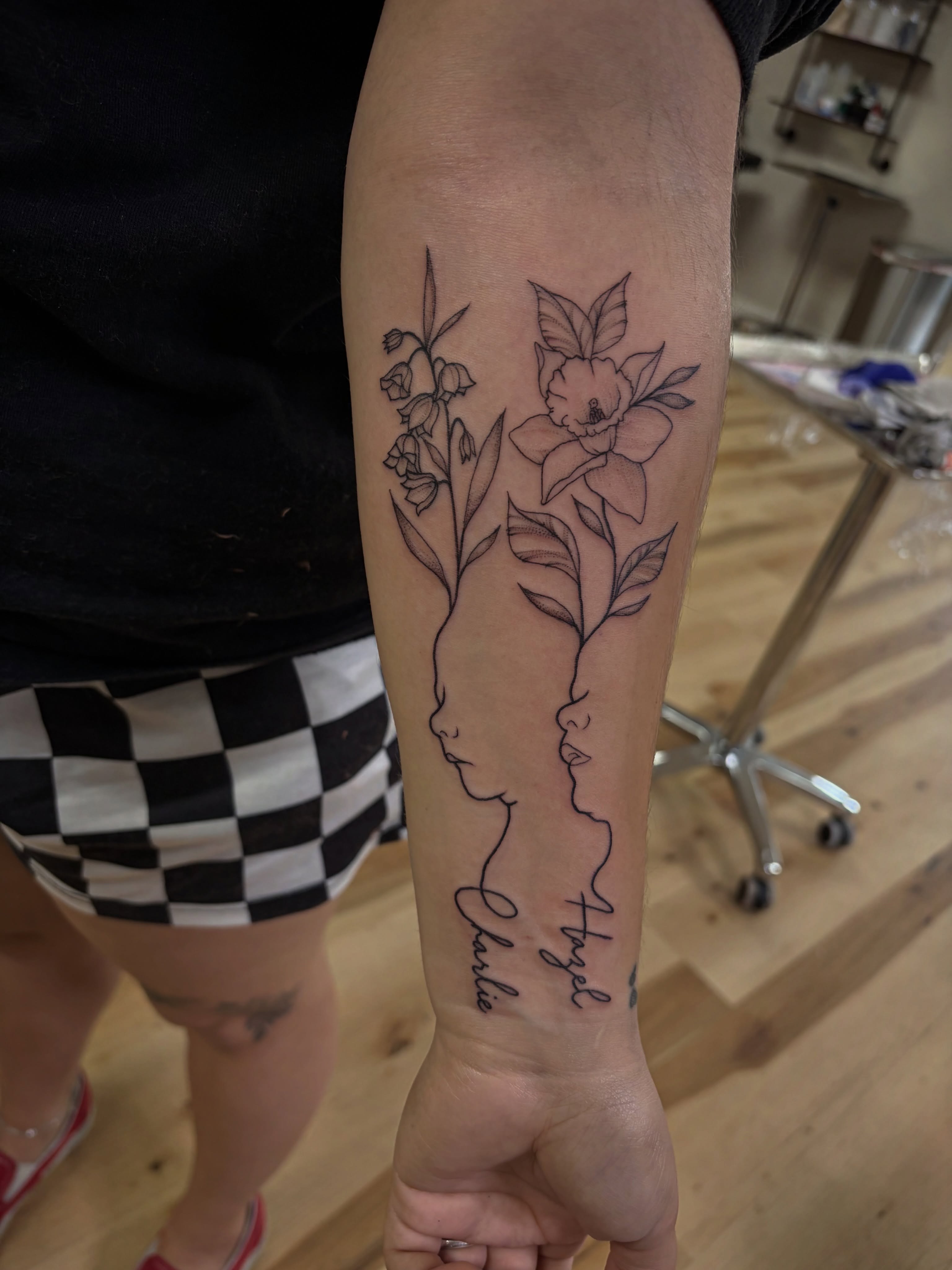 Floral profile fine line tattoo on the forearm by Francesca Siwa