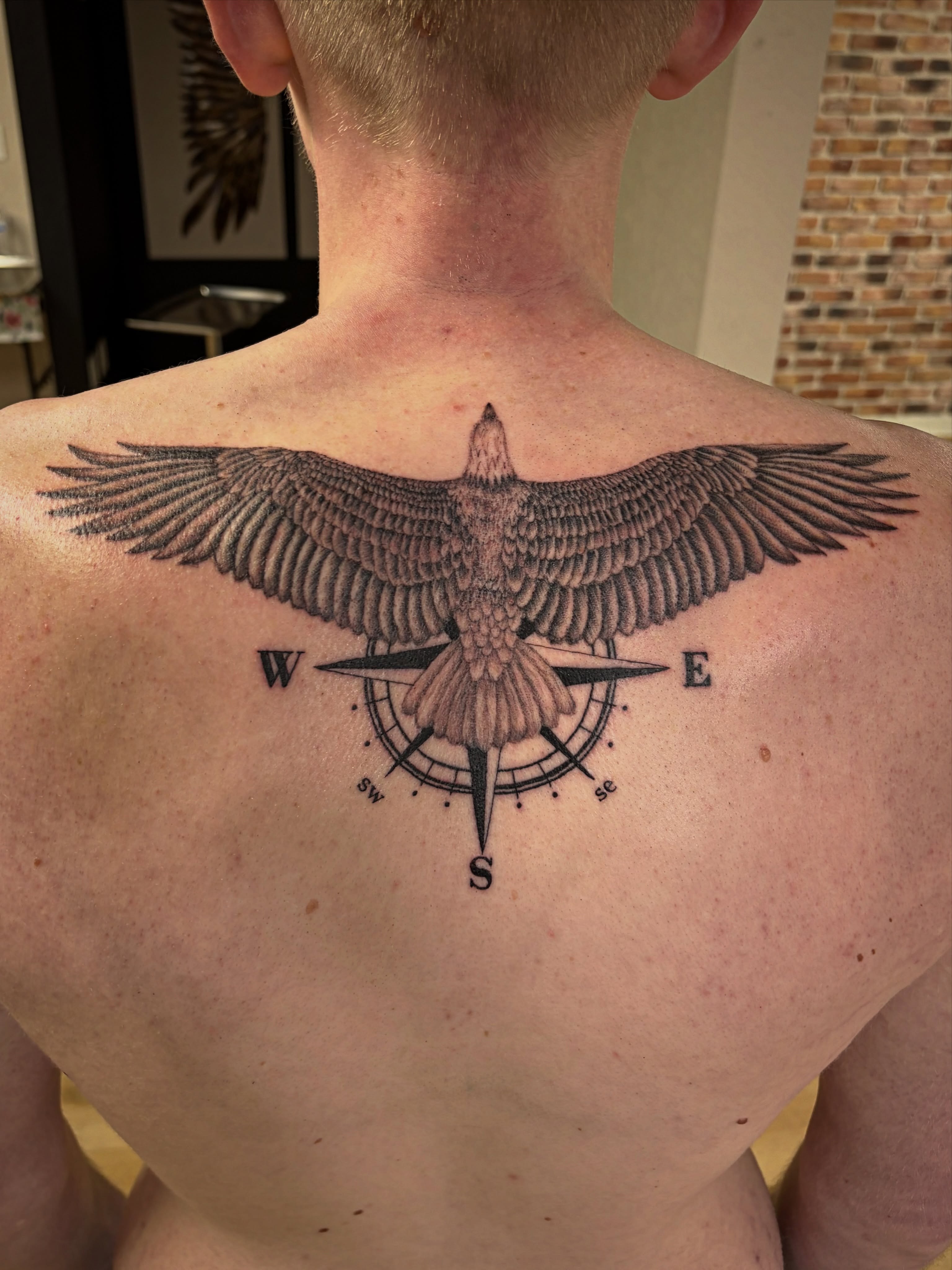 Eagle and compass black and grey tattoo on the back by Francesca Siwa