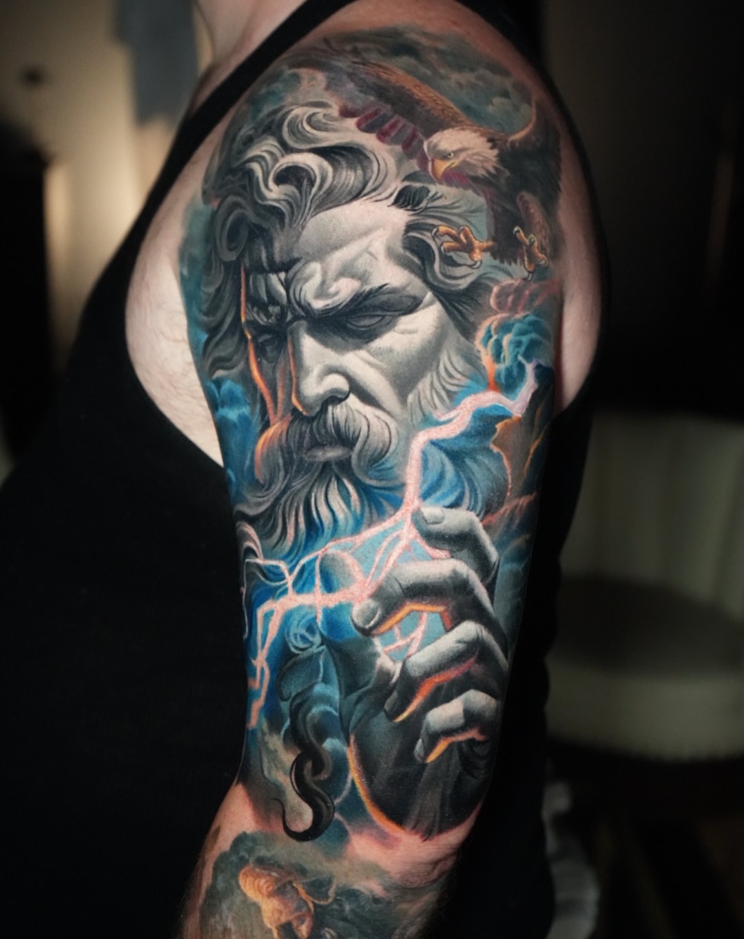 God with lightning realism tattoo on the upper arm by Robert Morton, Cleveland, Ohio