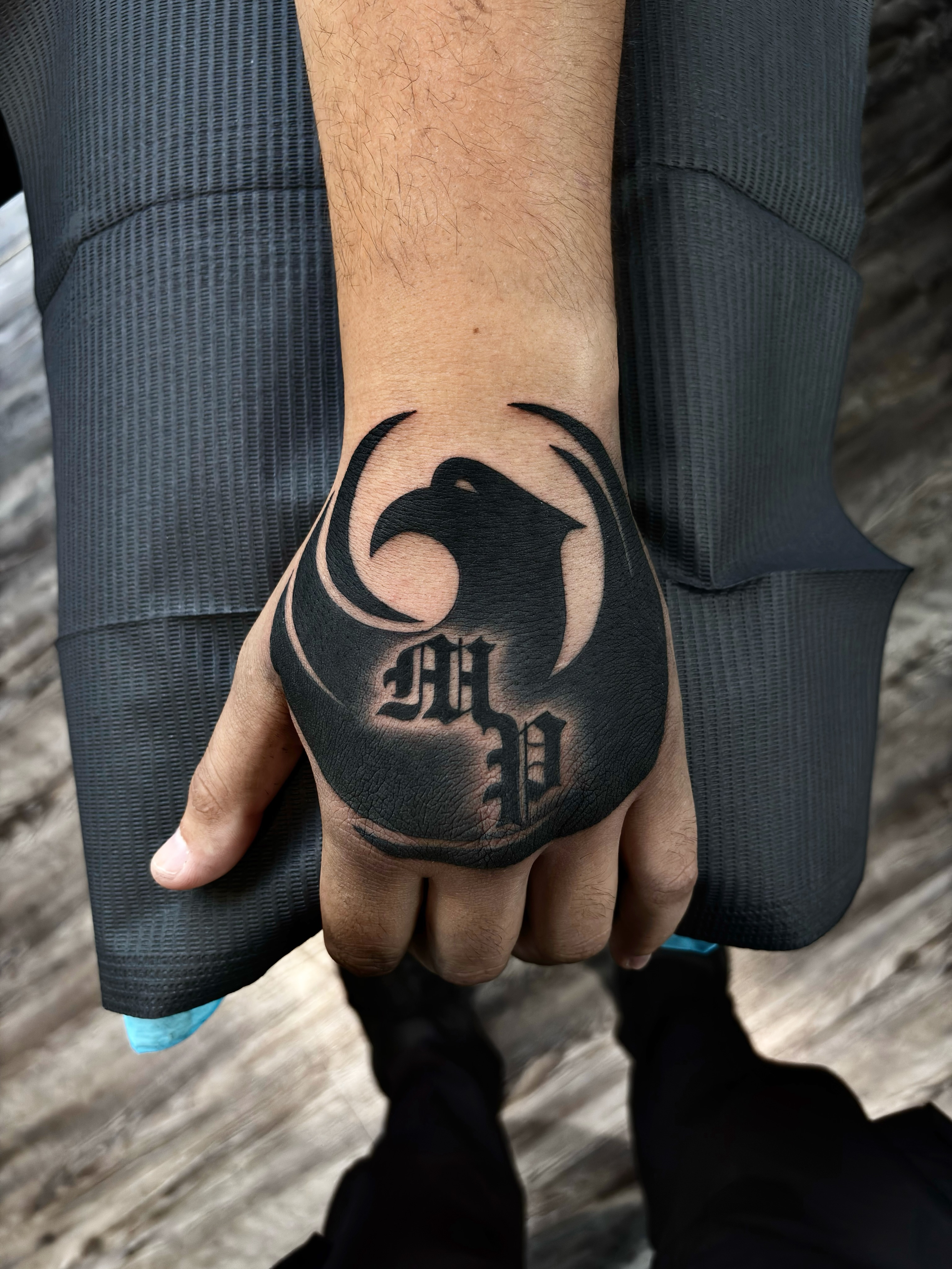 Bird black and grey tattoo on the hand by Luis Marrufo