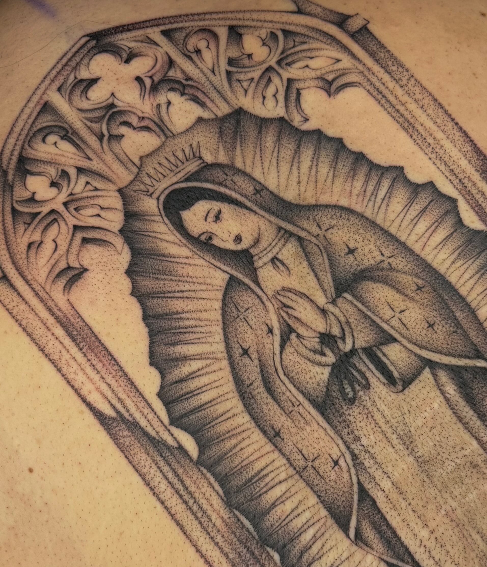 Our Lady of Guadalupe dotwork tattoo on the torso by Maggie Angulo